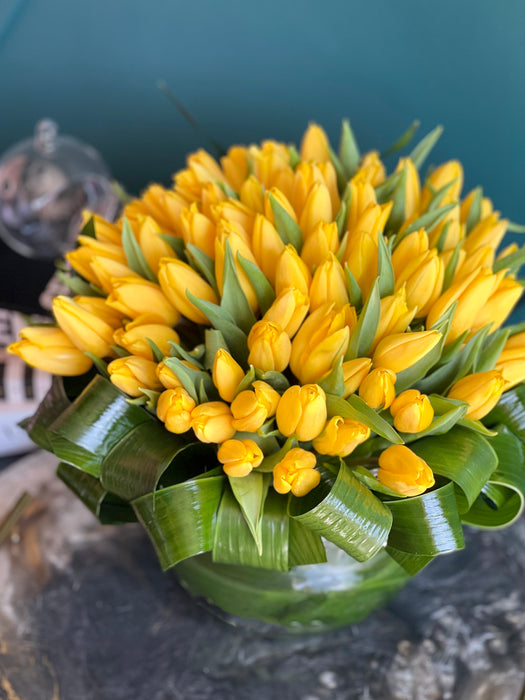 100 Yellow Tulips in Clear Vase