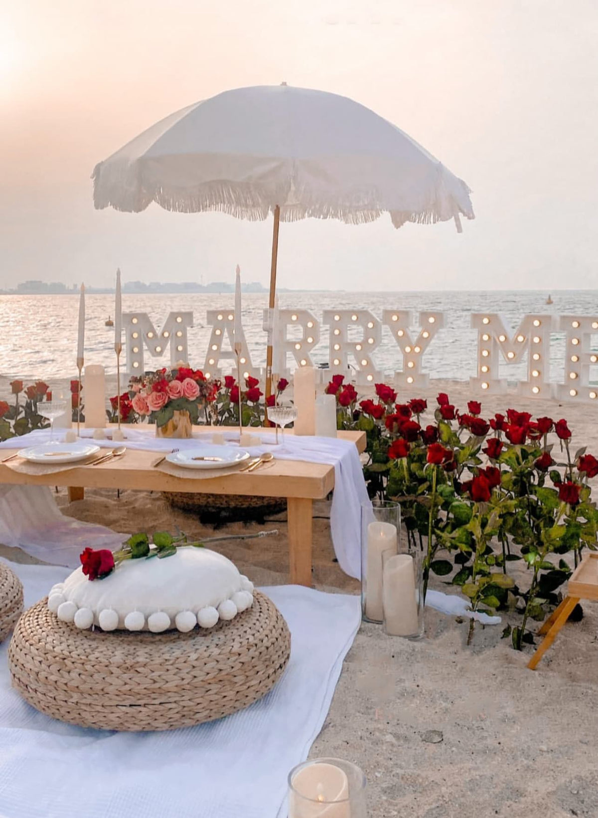 Romantic proposal setup in Miami with roses, candles and MARRY ME letters