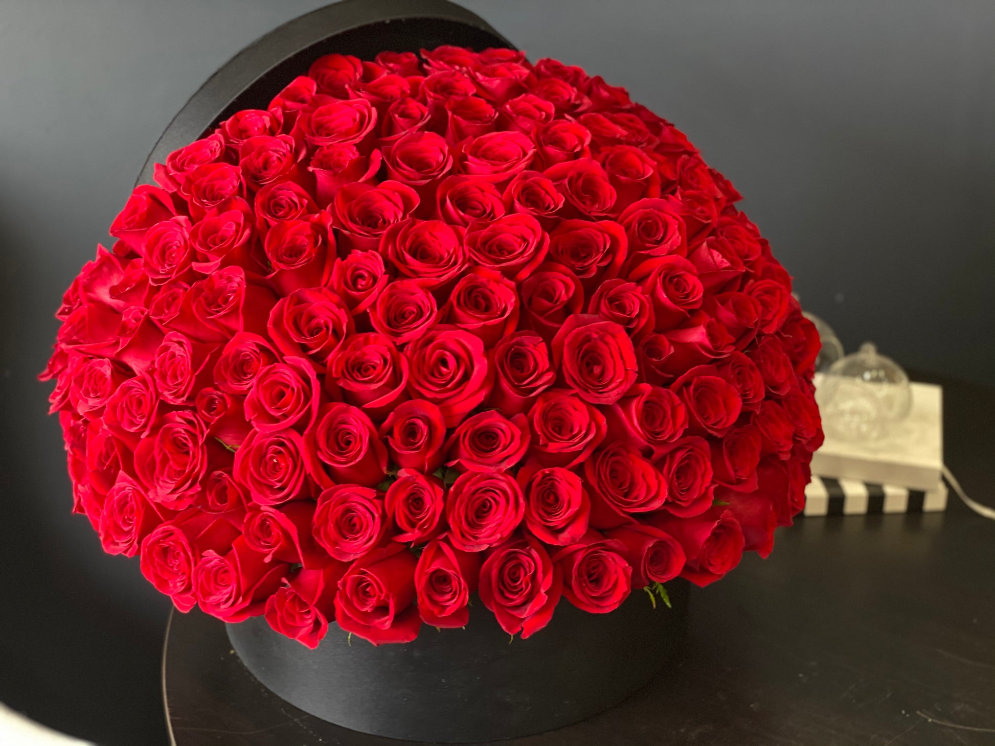 Large red rose arrangement with 150 roses in luxury black box