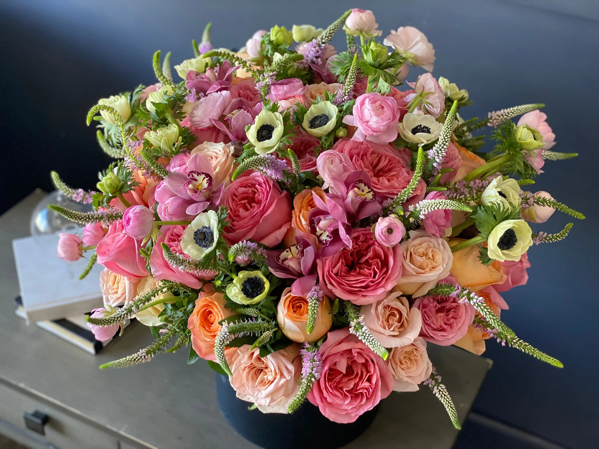 Large seasonal flower box with garden roses ranunculus and anemones