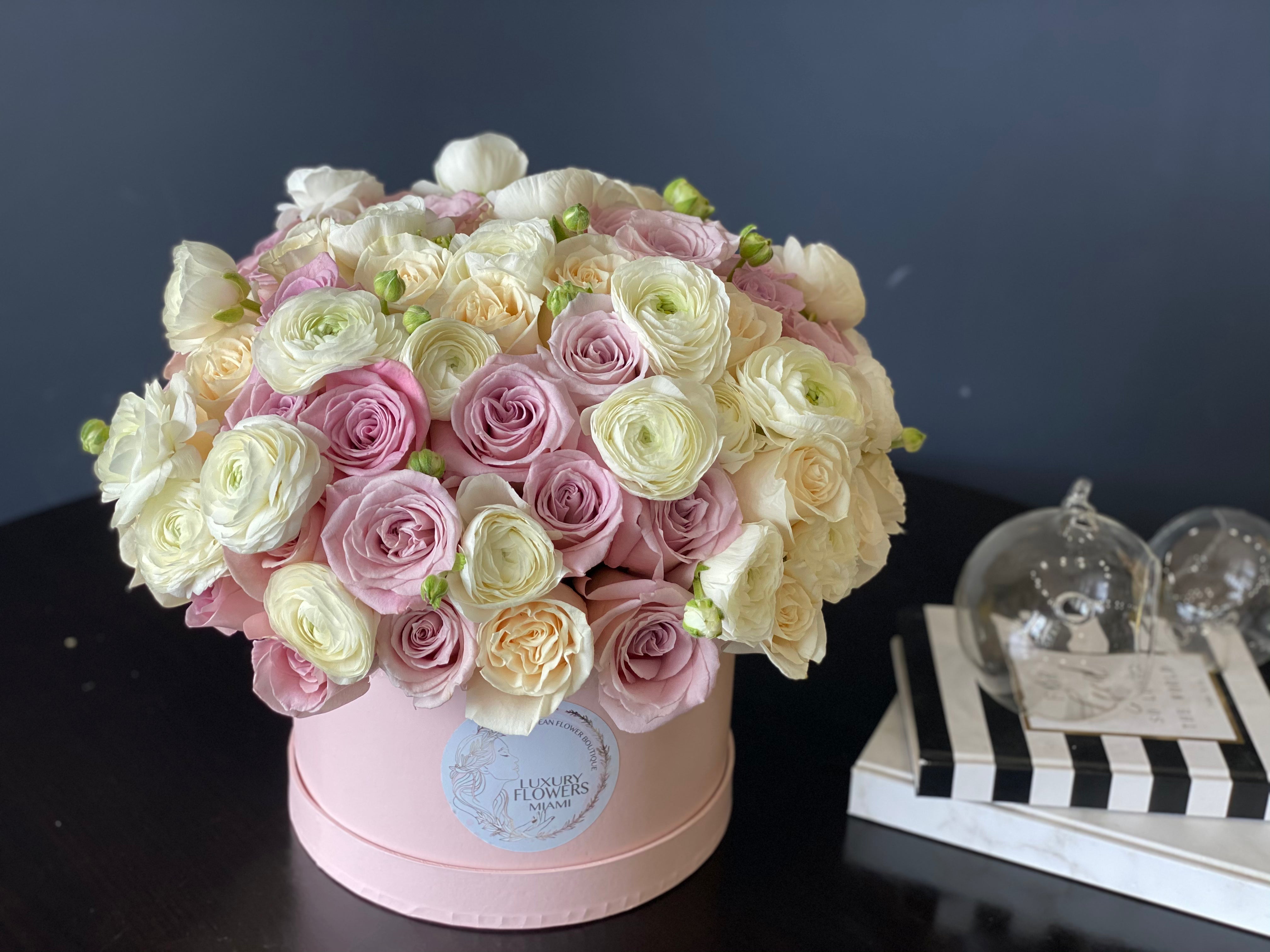 Lavender ivory roses and white ranunculus in flower box