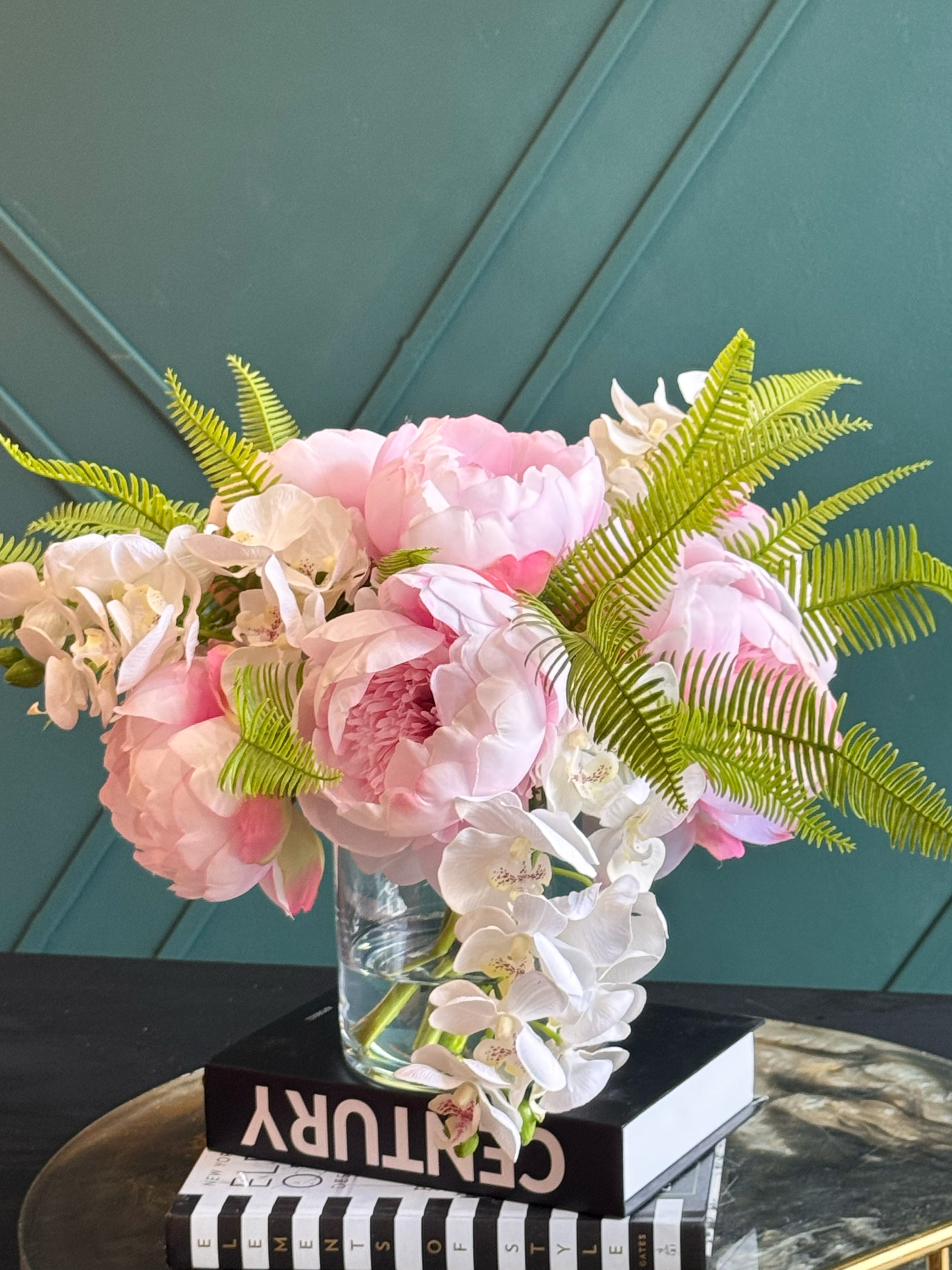 Luxury Real Touch flower arrangement featuring blush pink peonies, white orchids, and decorative fern leaves.