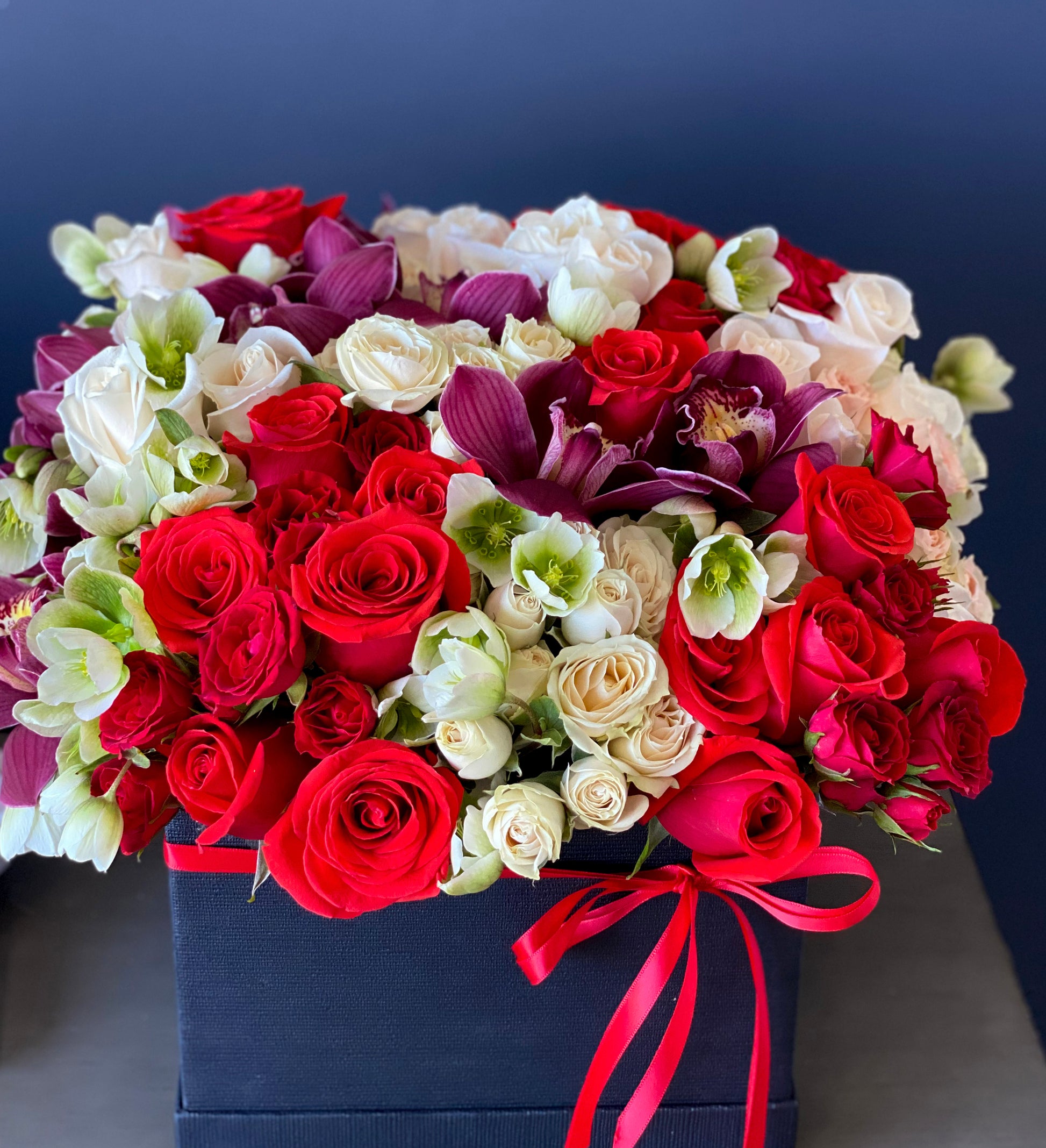 Luxury black flower box with red roses white roses and orchids