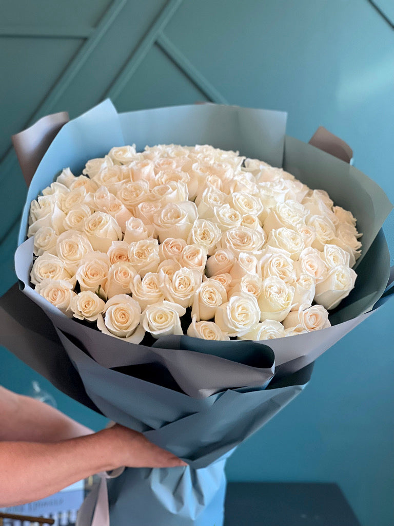 Luxury bouquet of 100 fresh white roses beautifully wrapped by Luxury Flowers Miami