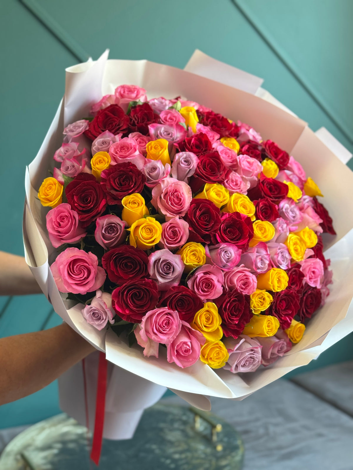 Luxury bouquet of 100 red pink and yellow roses
