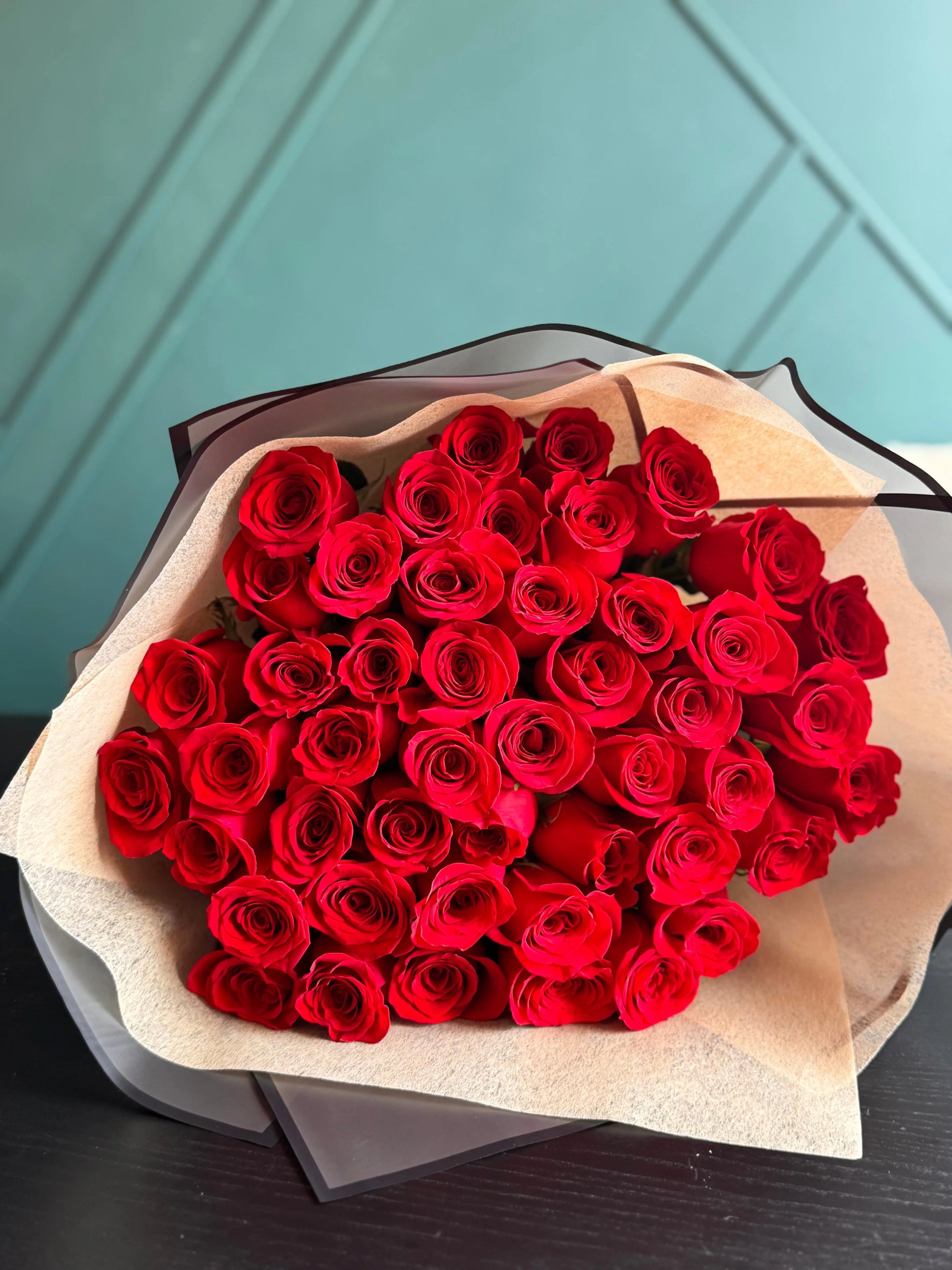 Luxury bouquet of 50 fresh red roses beautifully wrapped by Luxury Flowers Miami