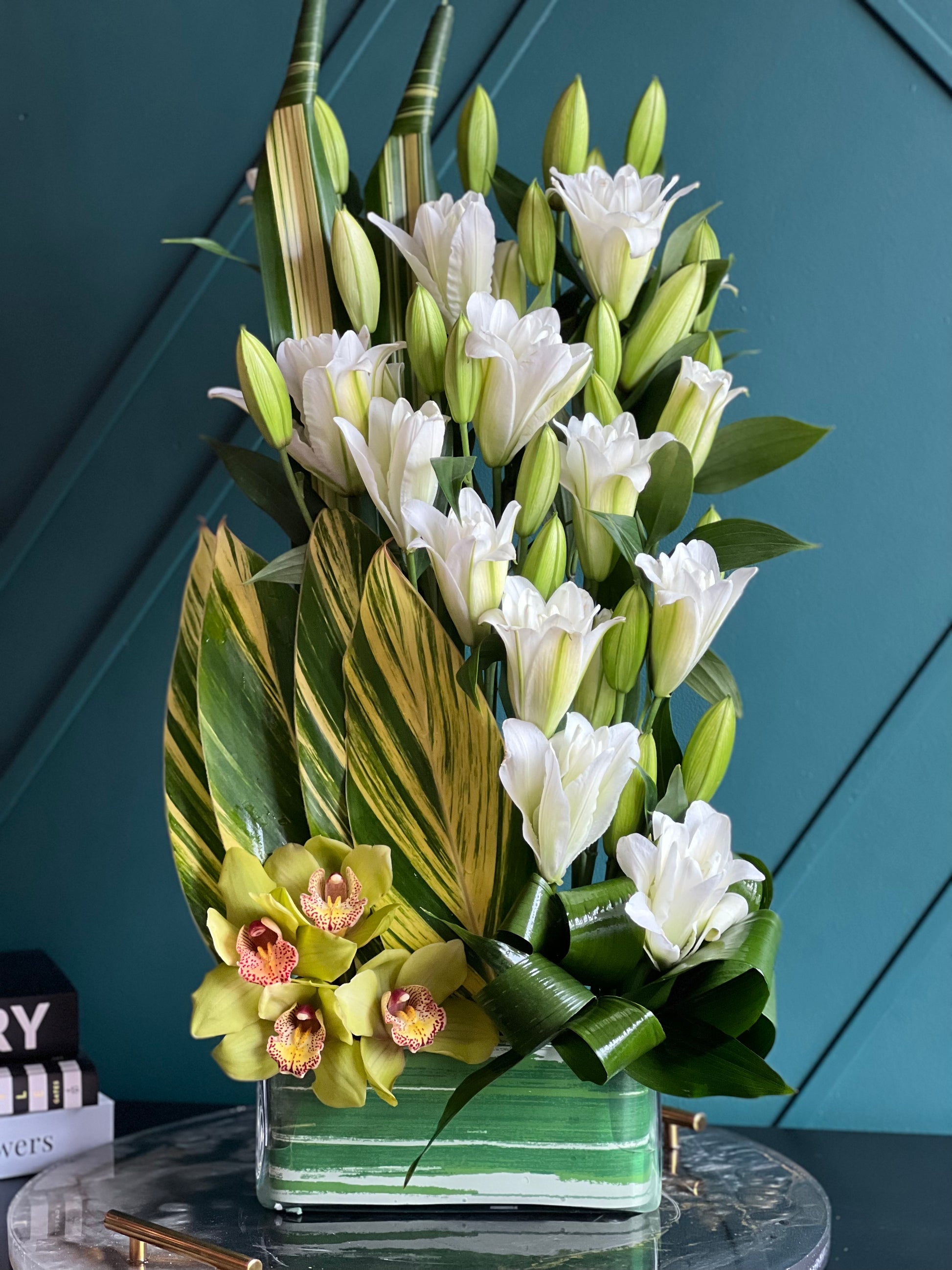 Luxury cymbidium orchid and white lily floral arrangement
