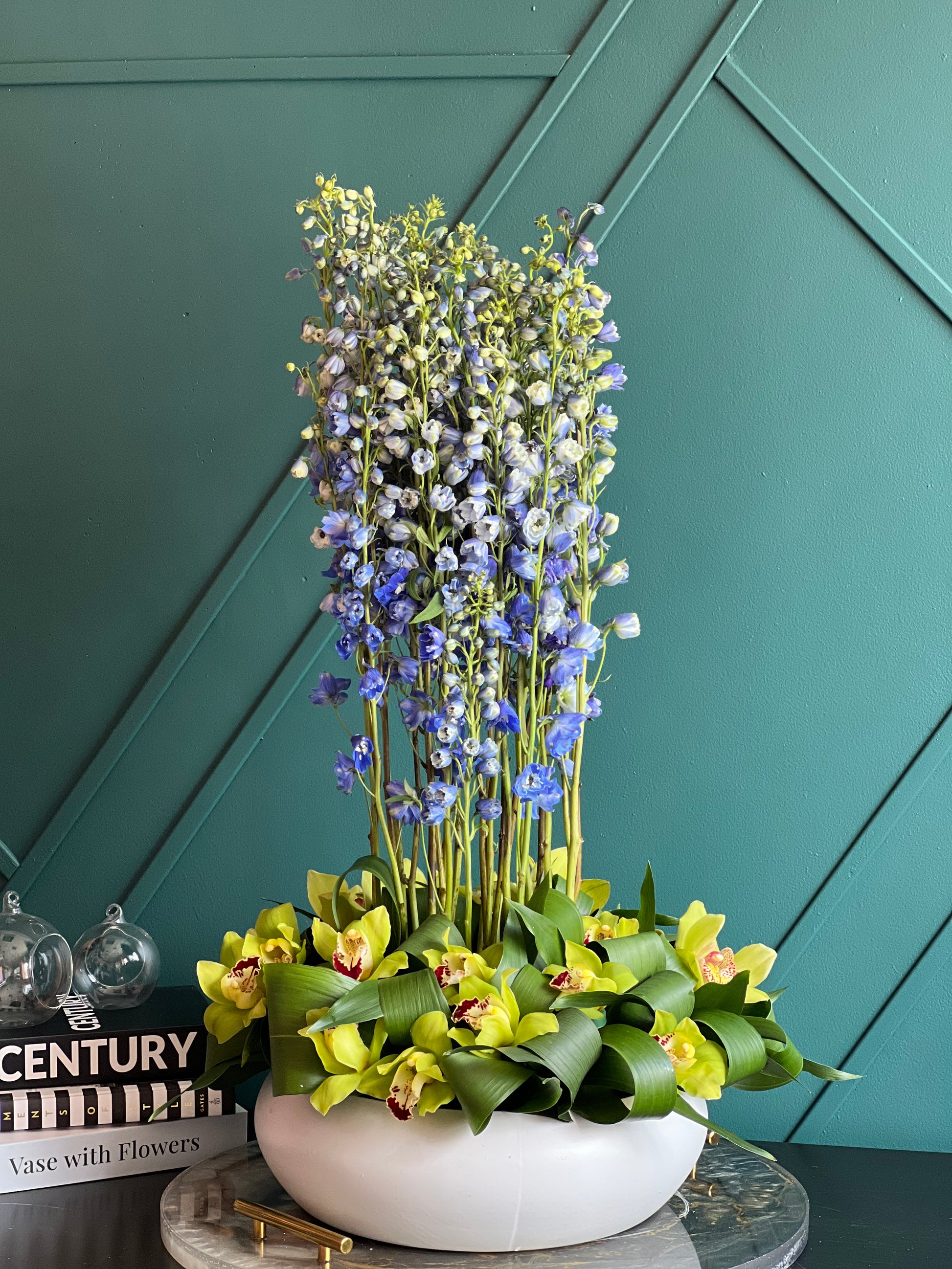 Luxury delphinium and cymbidium orchid arrangement in ceramic vase