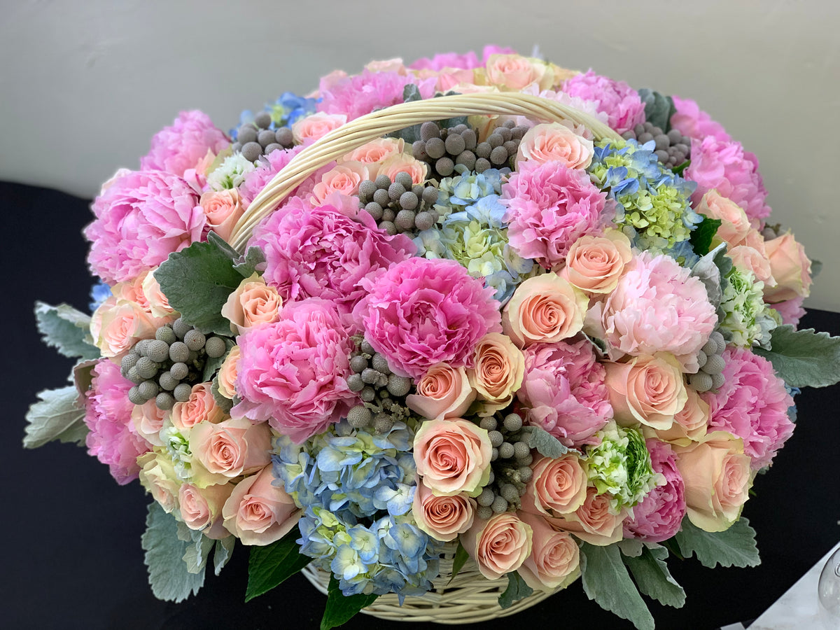 Luxury floral arrangement in elegant basket Miami Beach