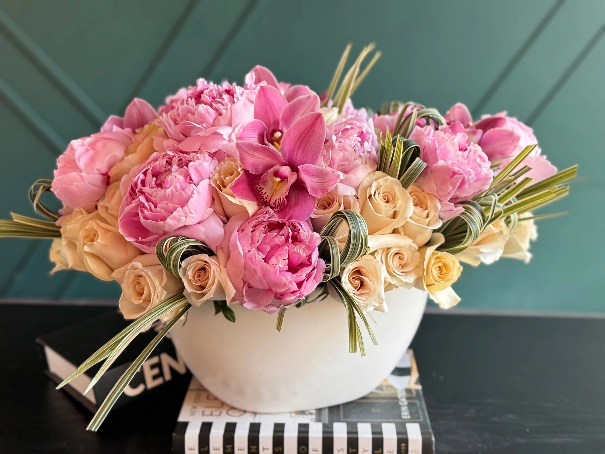Luxury floral gift with peonies orchids cappuccino roses and greenery