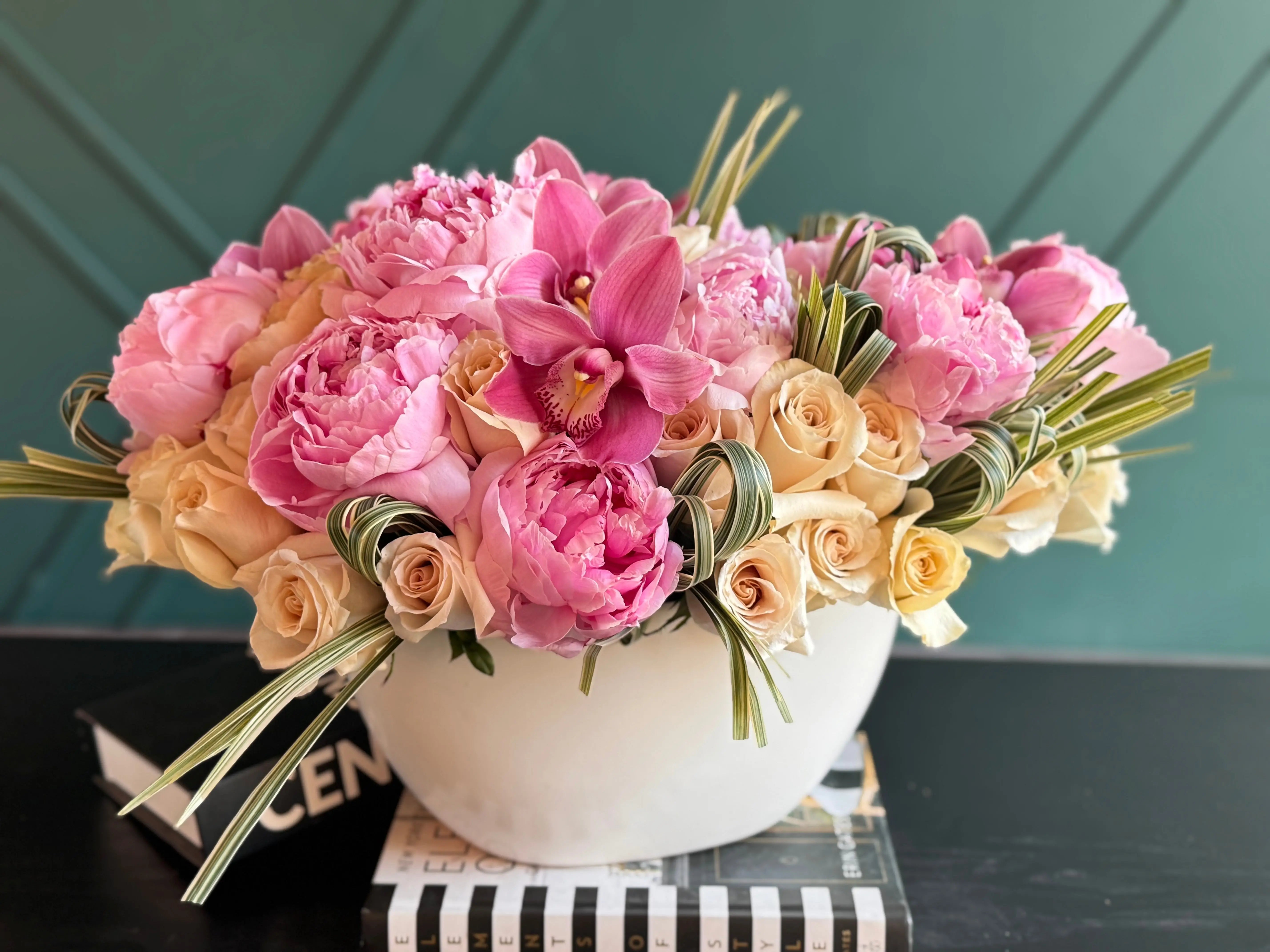 Luxury floral gift with peonies orchids cappuccino roses and greenery