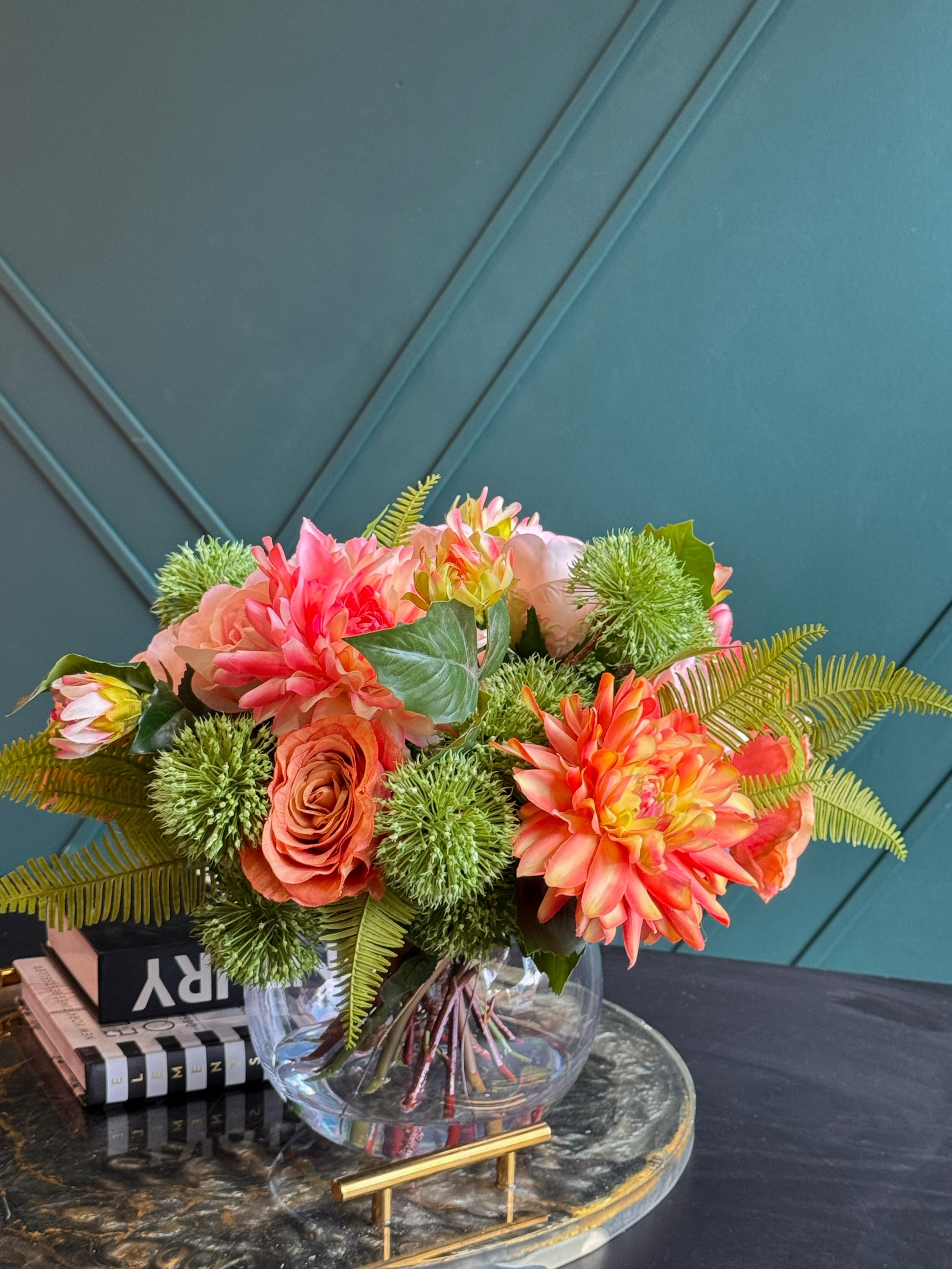 Luxury glass vase arrangement featuring lifelike pink and coral flowers.