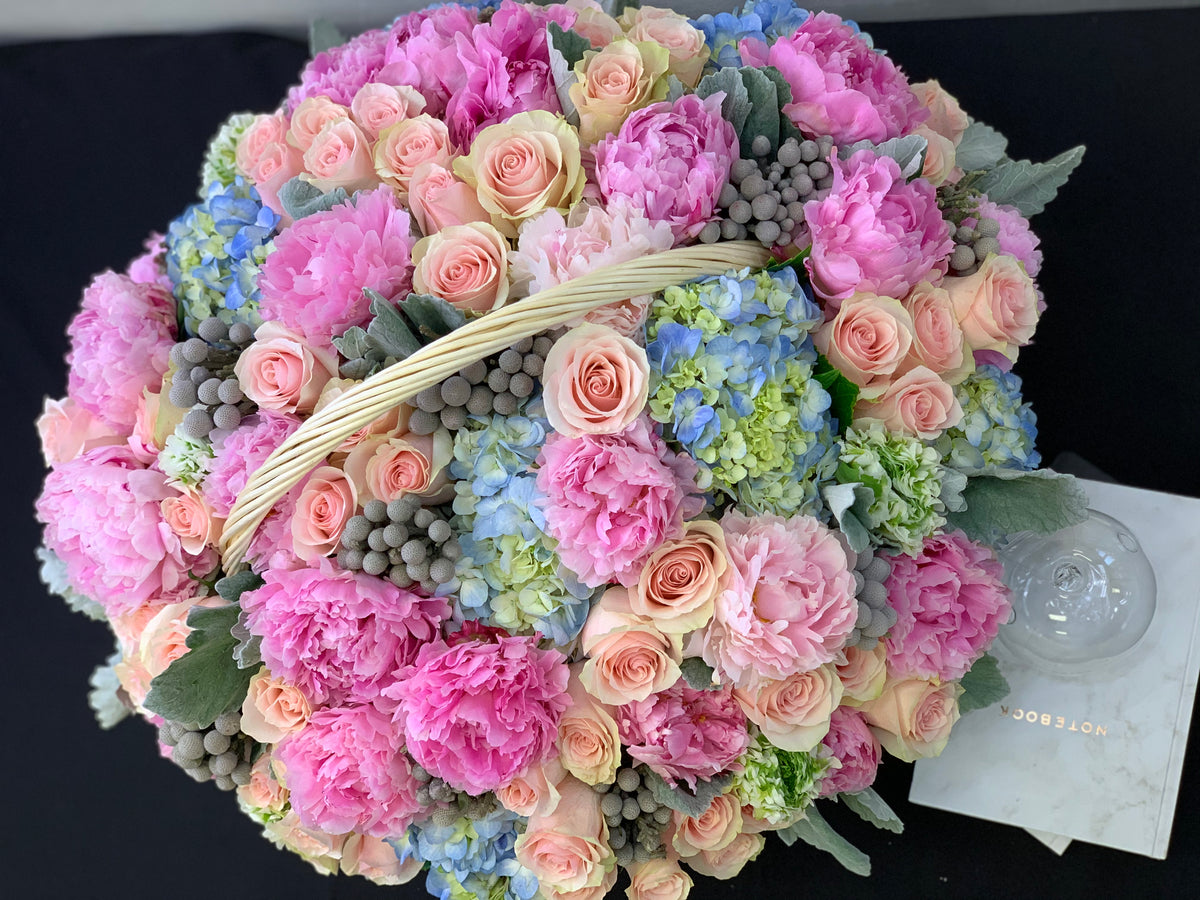 Luxury mixed flower arrangement in handled basket Miami