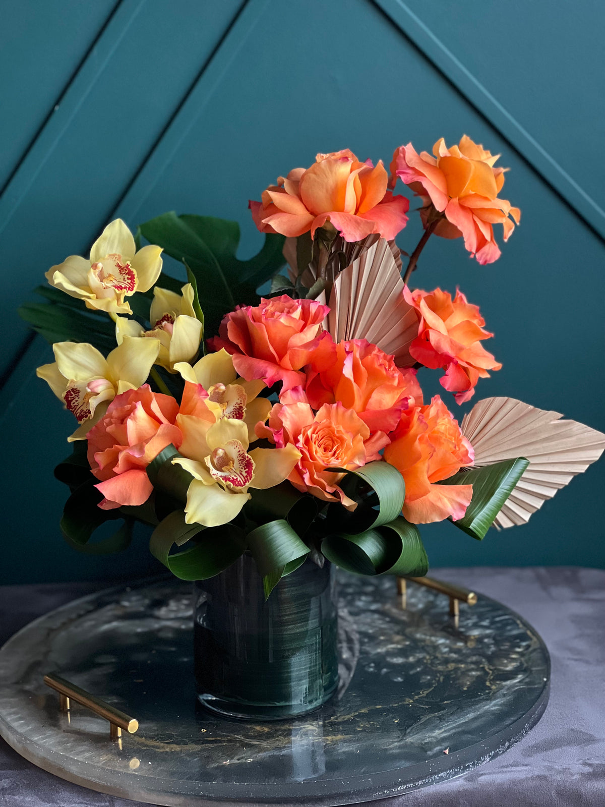 Luxury orange roses and cymbidium orchids in modern glass vase