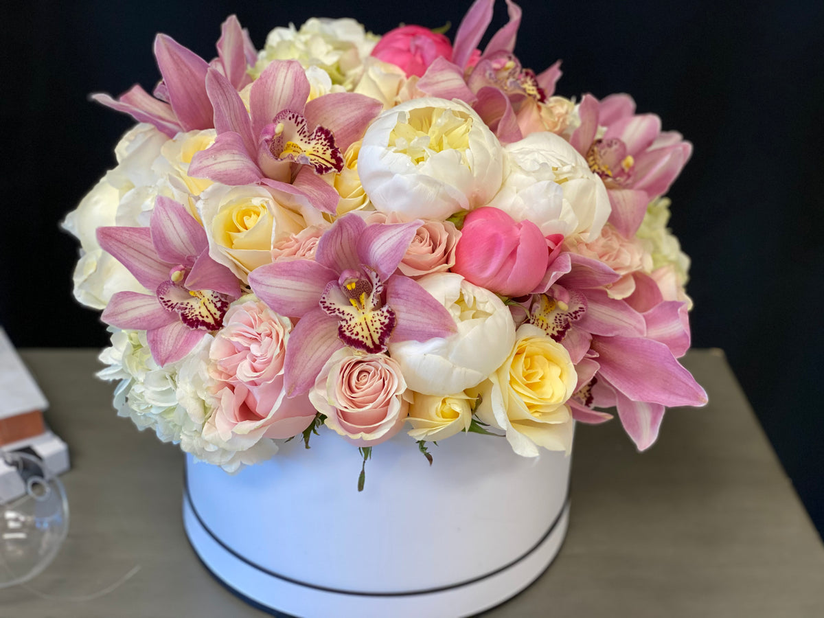 Luxury pink floral arrangement in elegant round flower box