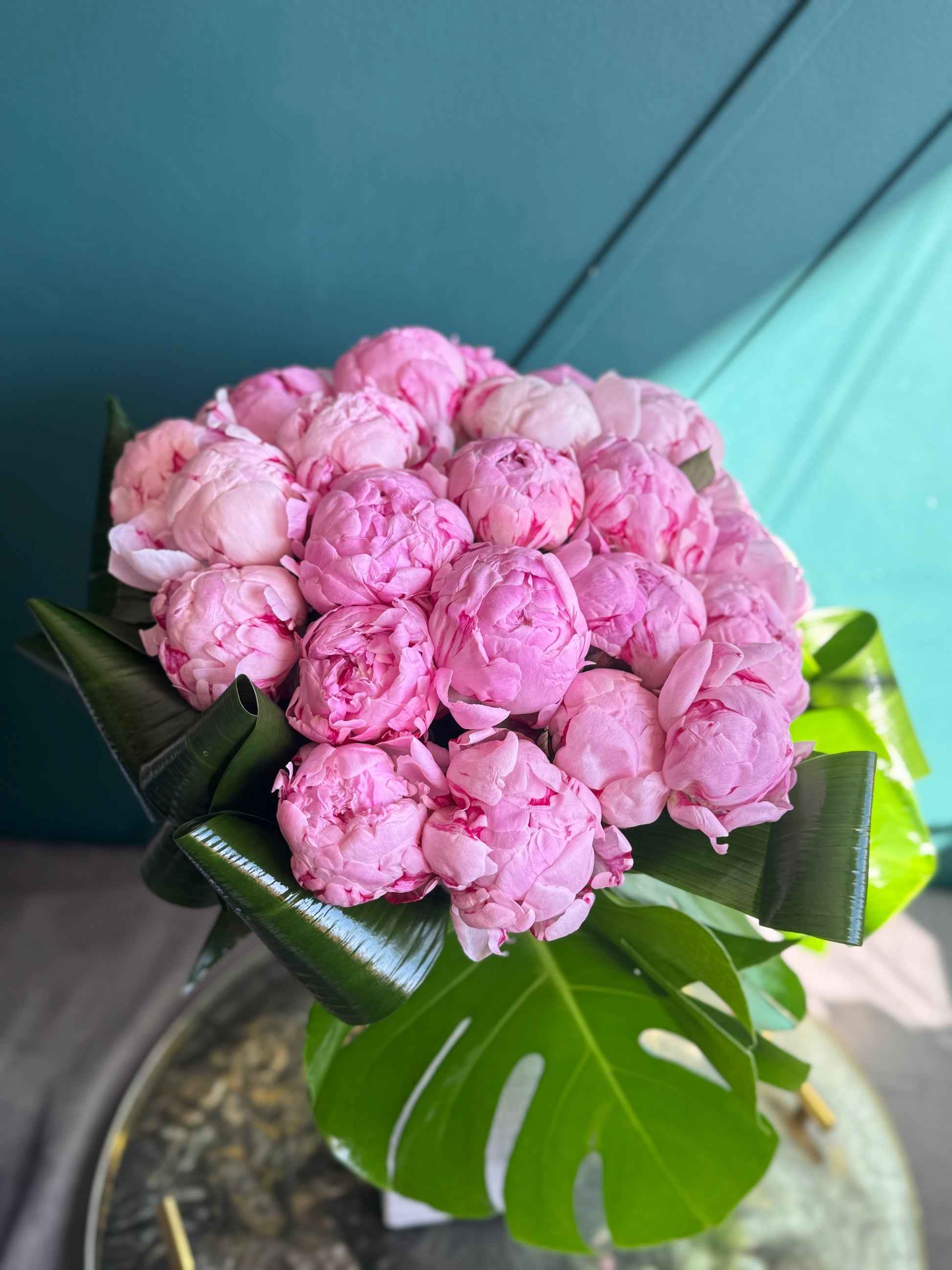 Luxury pink peony arrangement with tropical greenery in Miami Beach