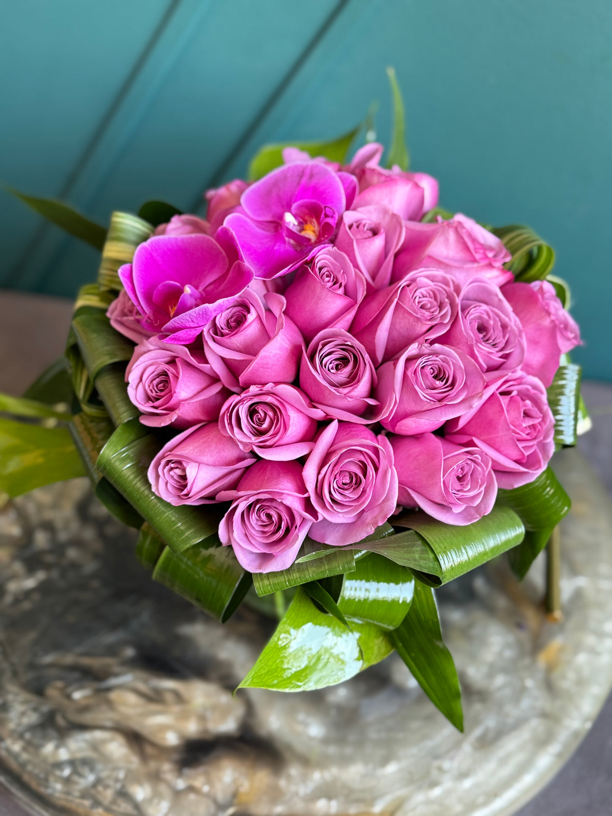Luxury purple rose arrangement with decorative greenery
