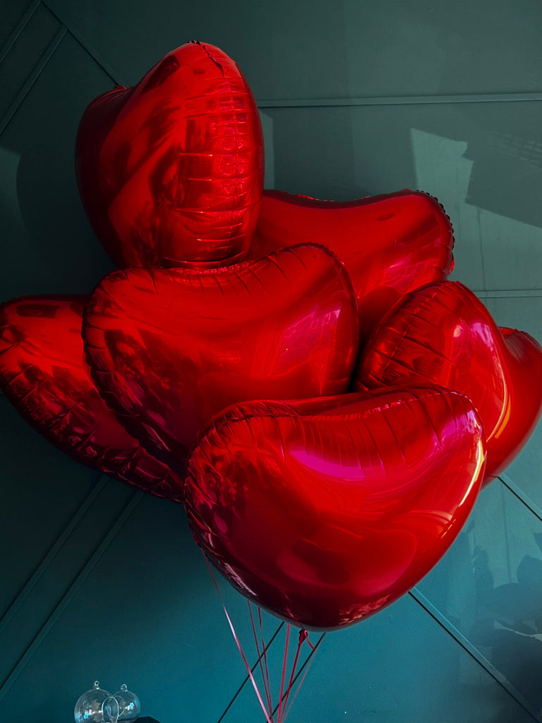 Luxury red heart balloons arranged by Luxury Flowers Miami