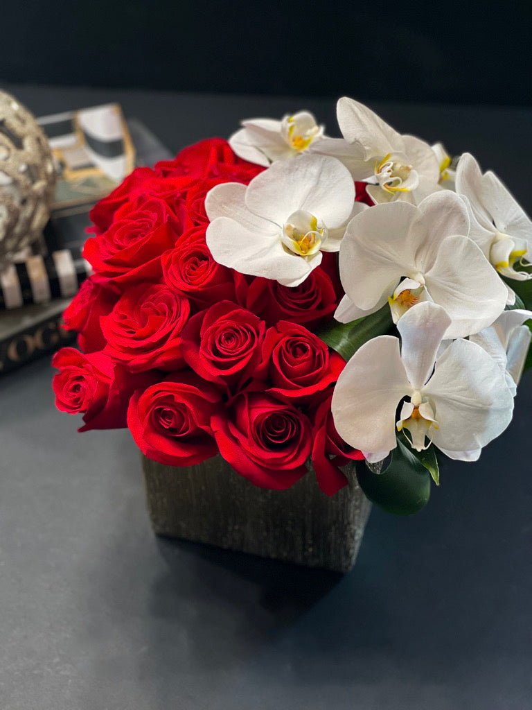Luxury red roses and white orchids in a vase