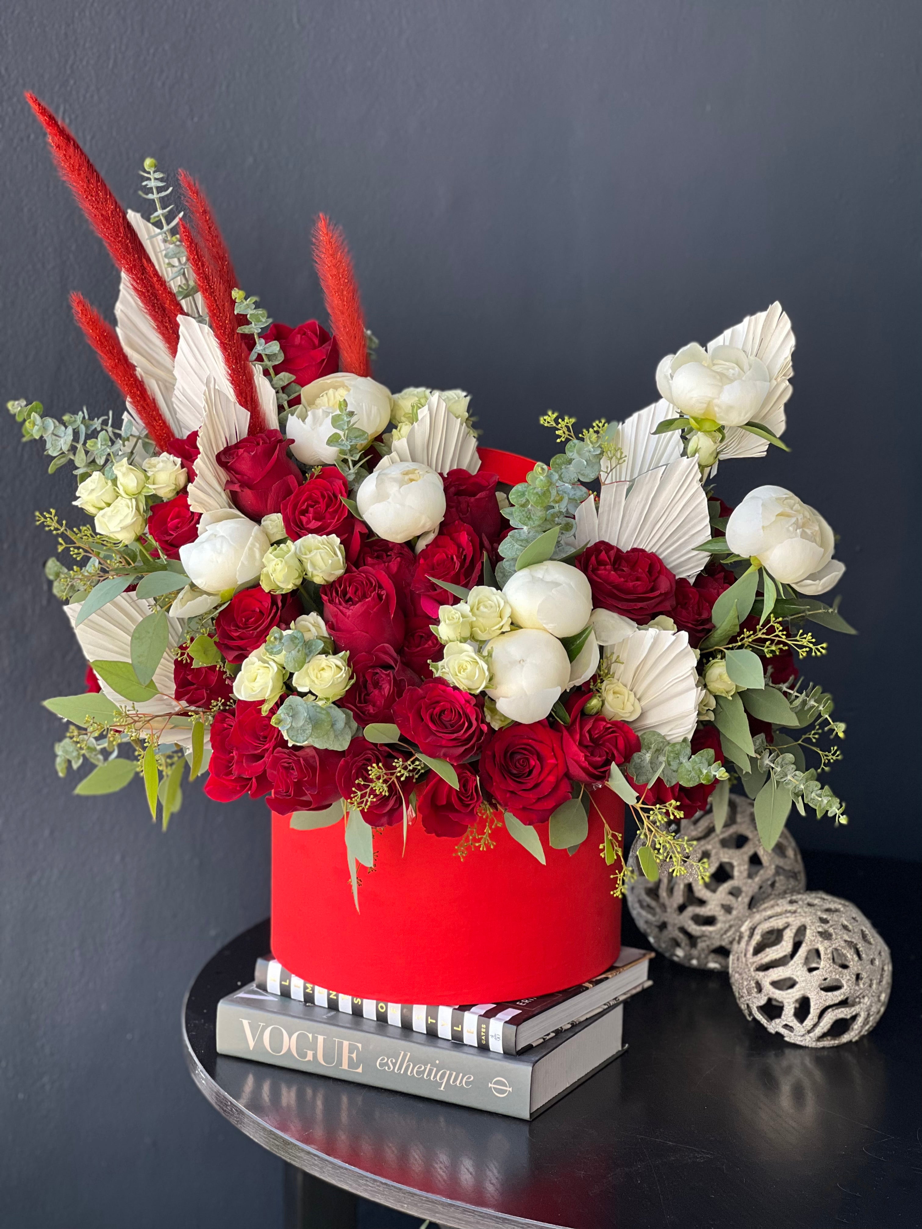 Luxury red roses and white peonies arrangement in red flower box Miami