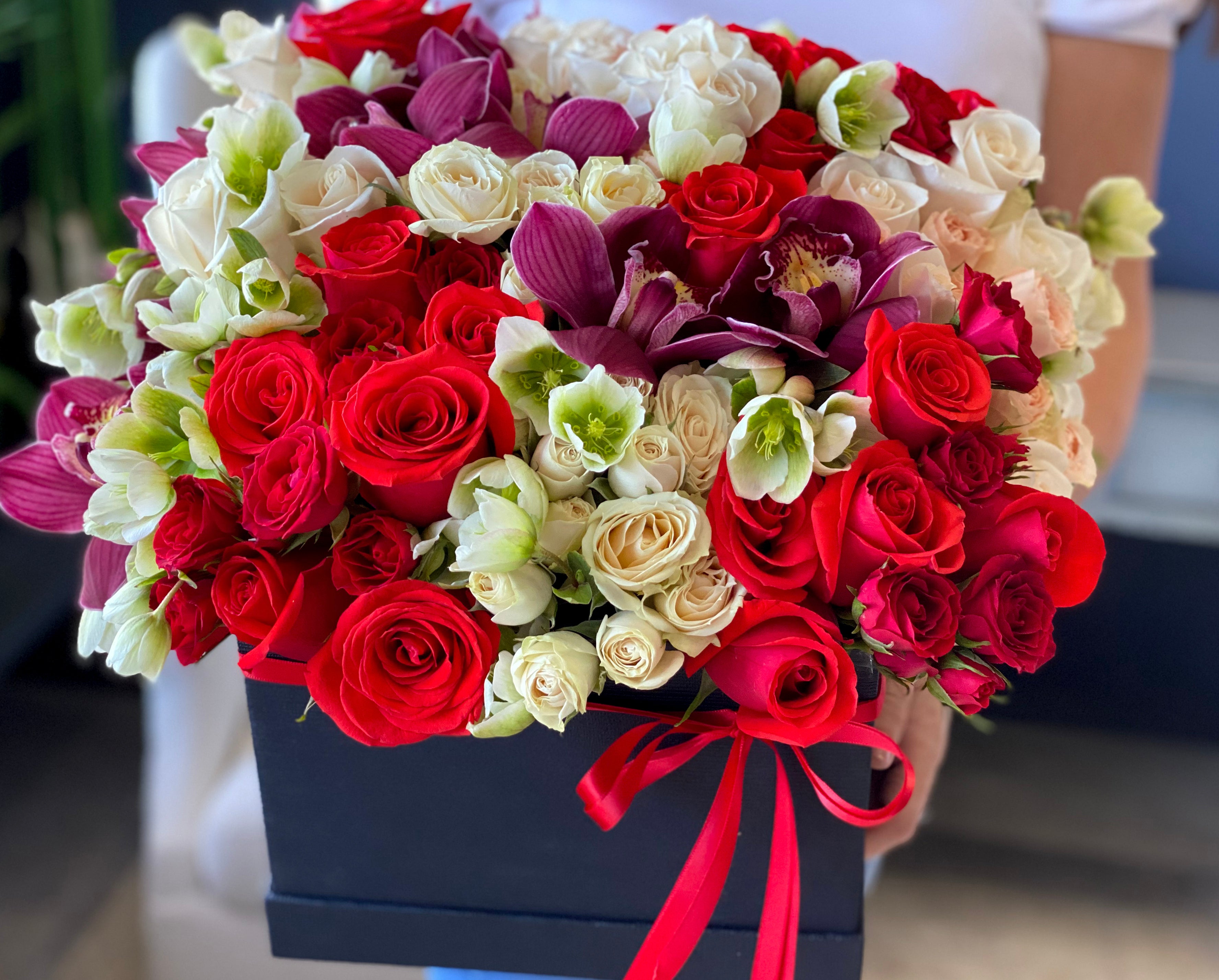 Luxury roses and cymbidium orchid flower box with fresh greenery Miami