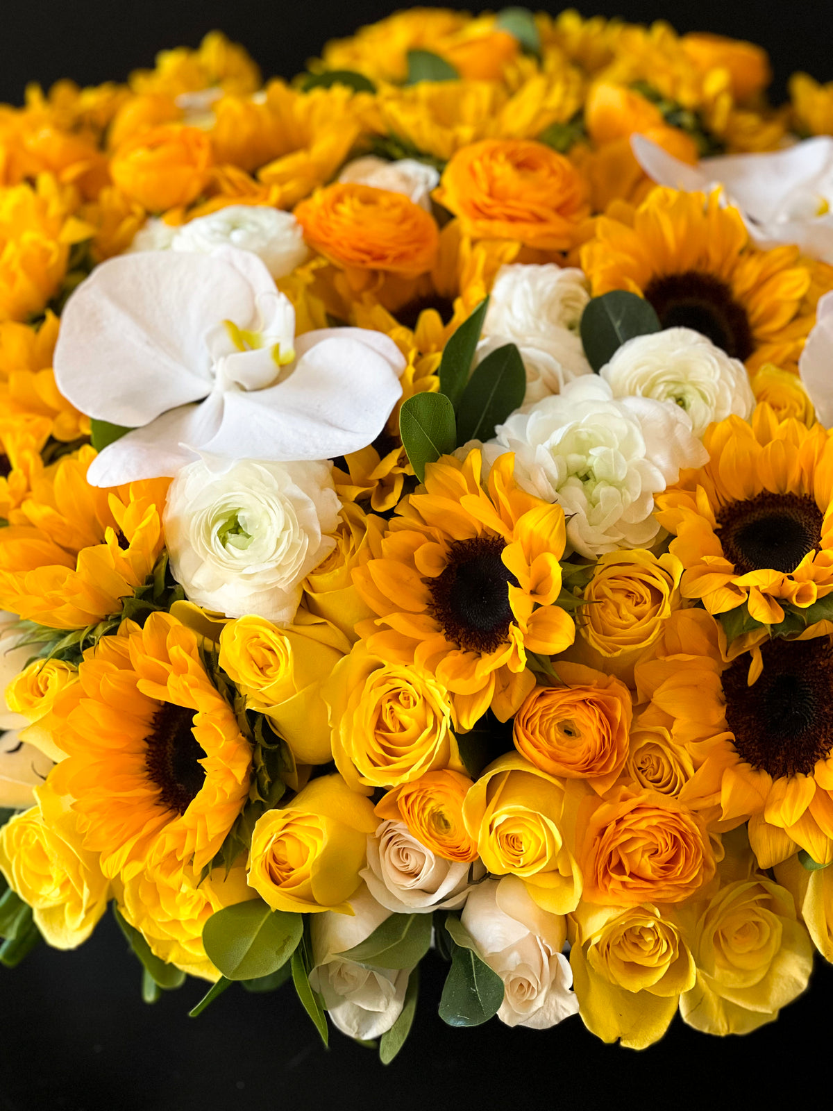 Luxury sunflower arrangement with white Phalaenopsis orchids