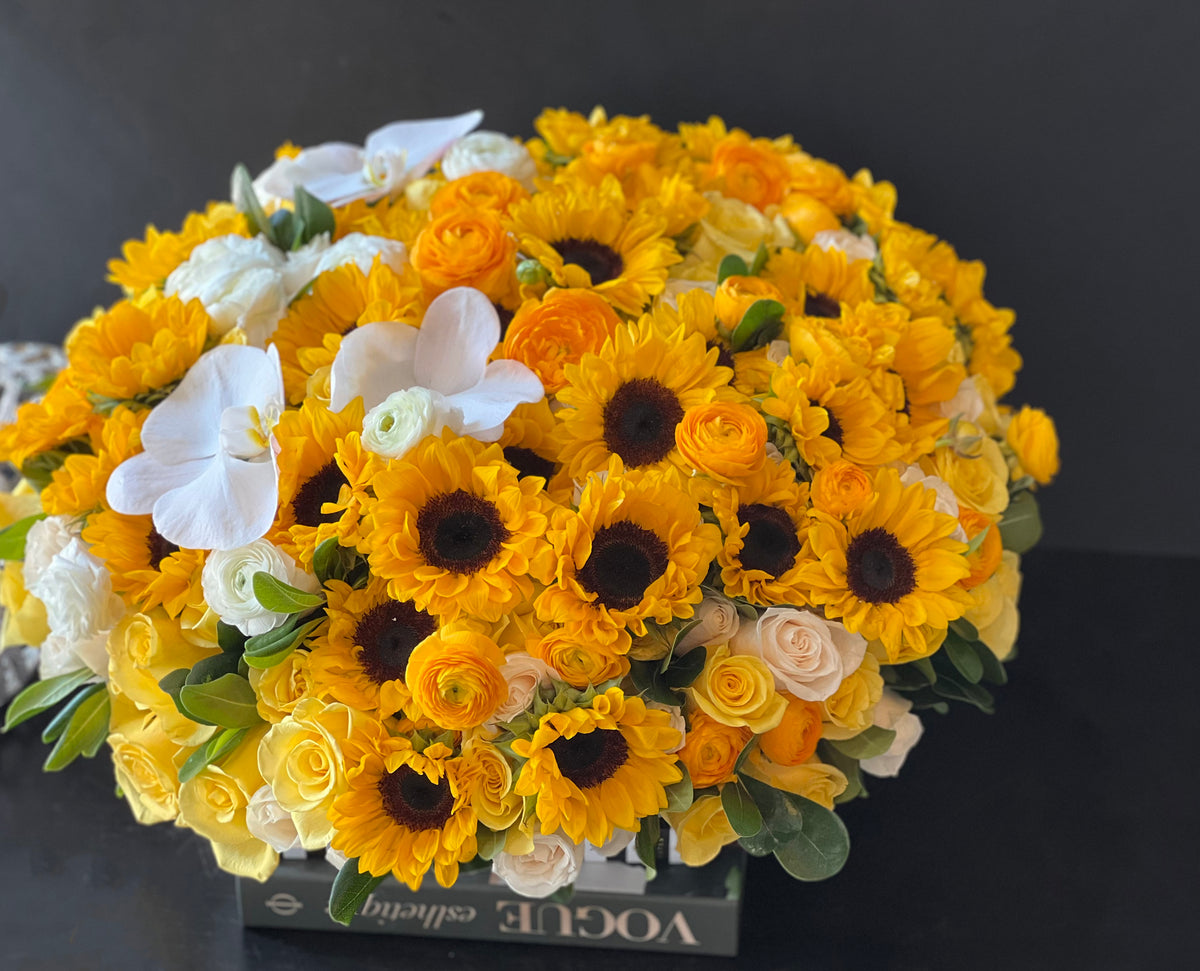 Luxury sunflower centerpiece with roses and white orchids