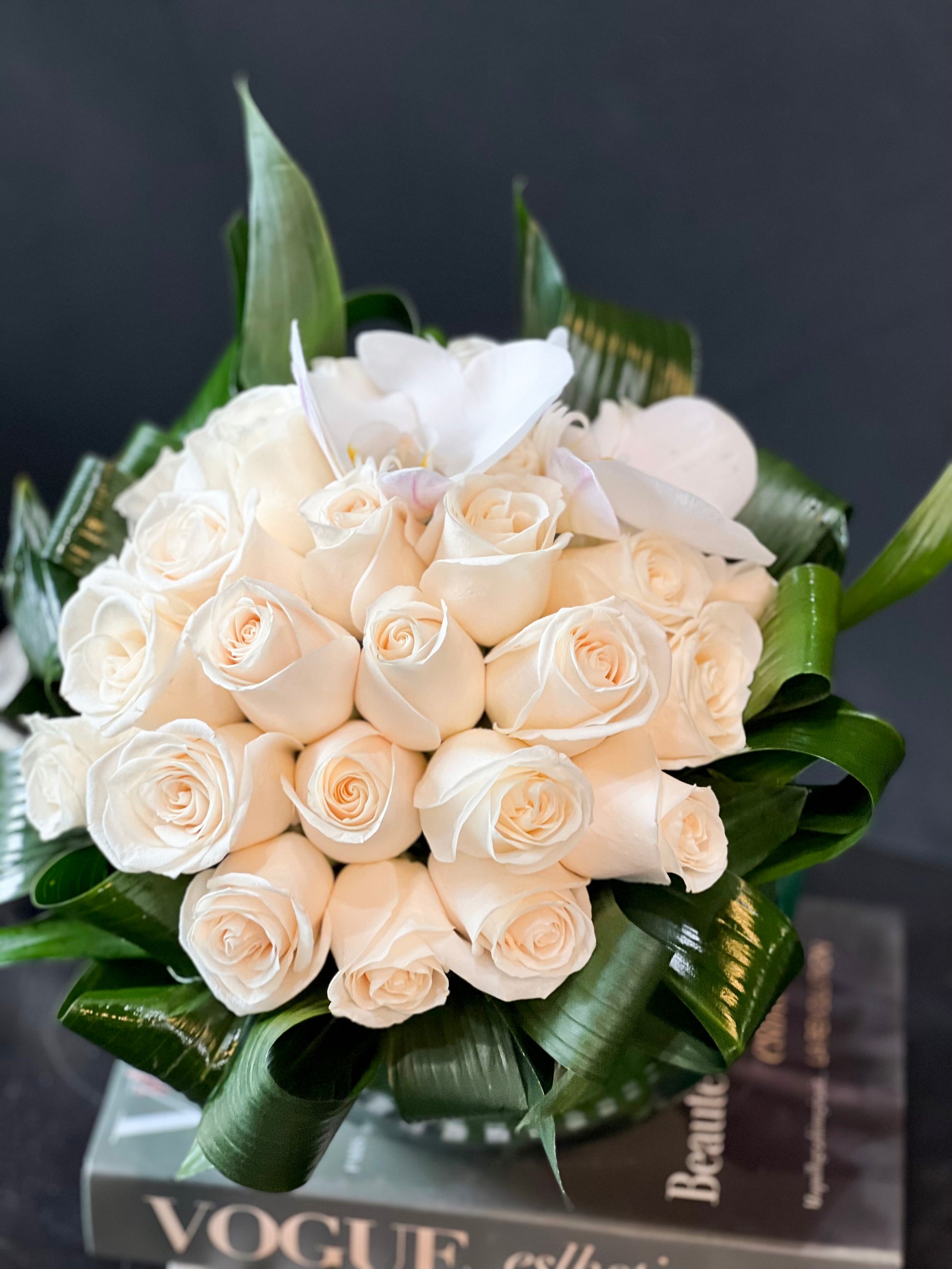 Luxury white rose arrangement in a round glass vase by Luxury Flowers Miami