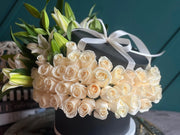 Luxury white roses and fragrant lilies in a black flower box in Miami