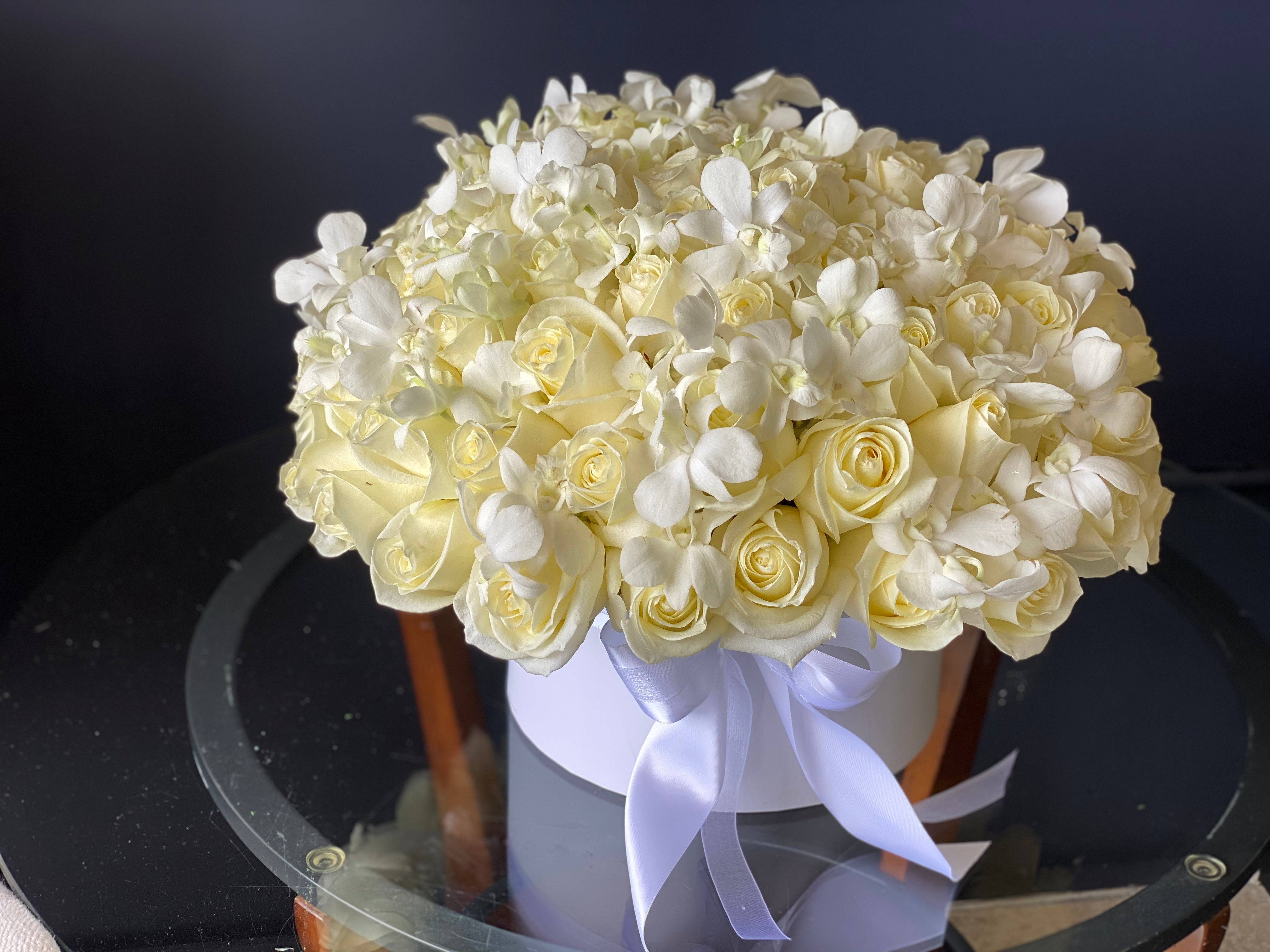 Luxury white roses and orchids in a flower box
