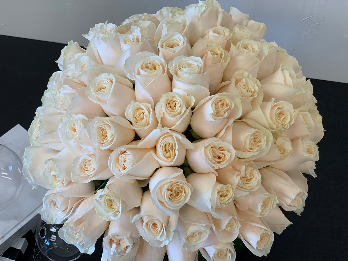 Luxury white roses in fishbowl vase by Luxury Flowers Miami