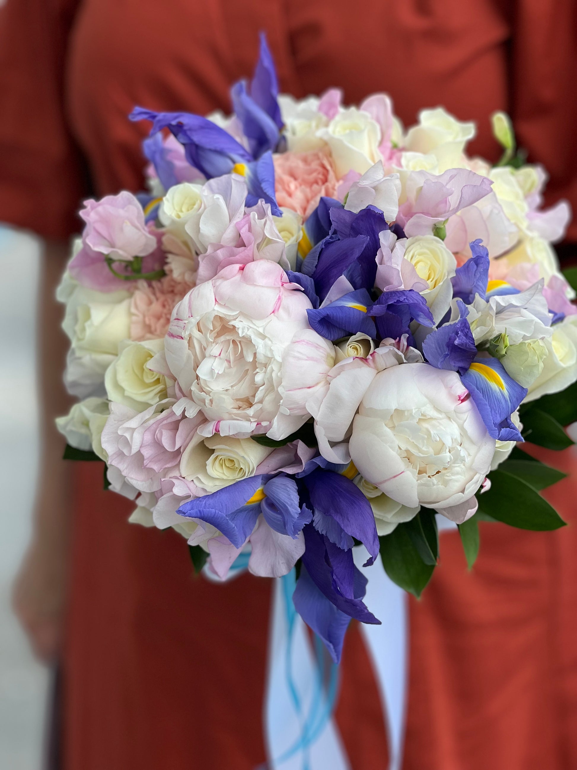 Miami bridal bouquet with peonies roses blue iris and flowing ribbons