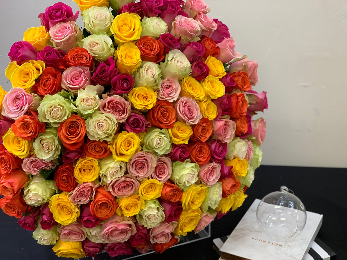 Mixed color roses with pink yellow orange and peach blooms