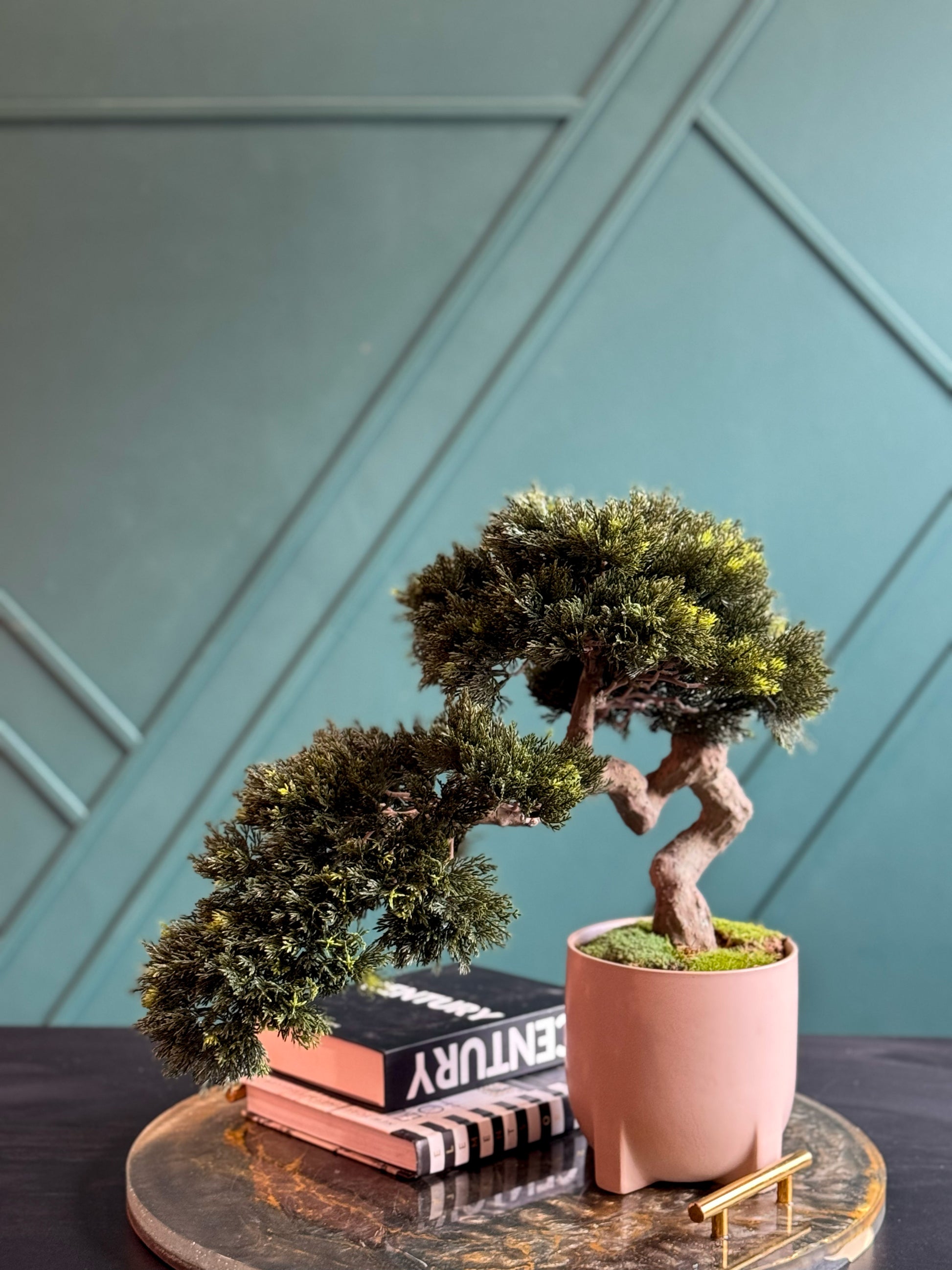Modern artificial bonsai centerpiece with realistic evergreen foliage.