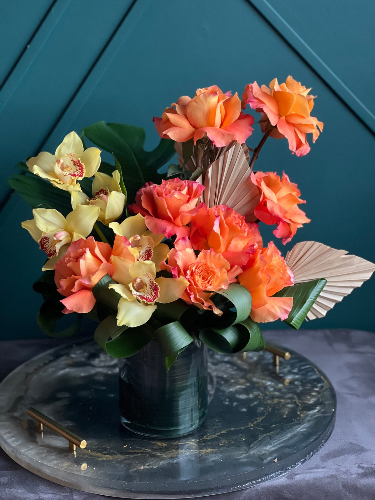 Modern orange flower arrangement with yellow cymbidium orchids Miami