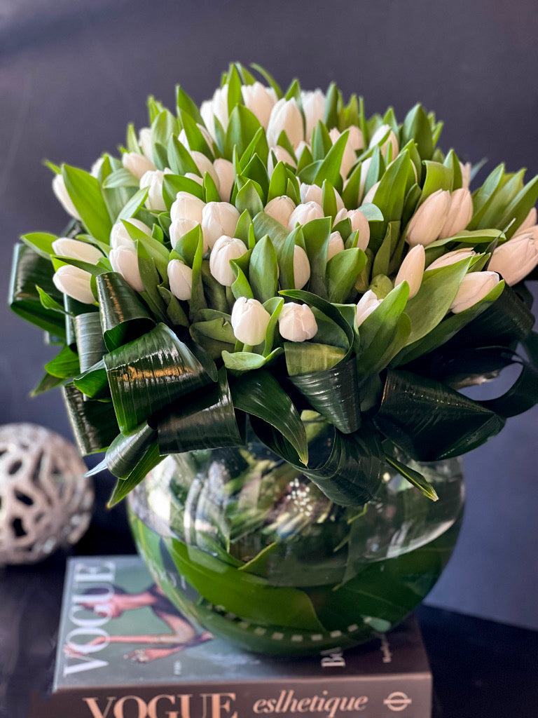 Modern white tulip centerpiece in clear glass bowl 
