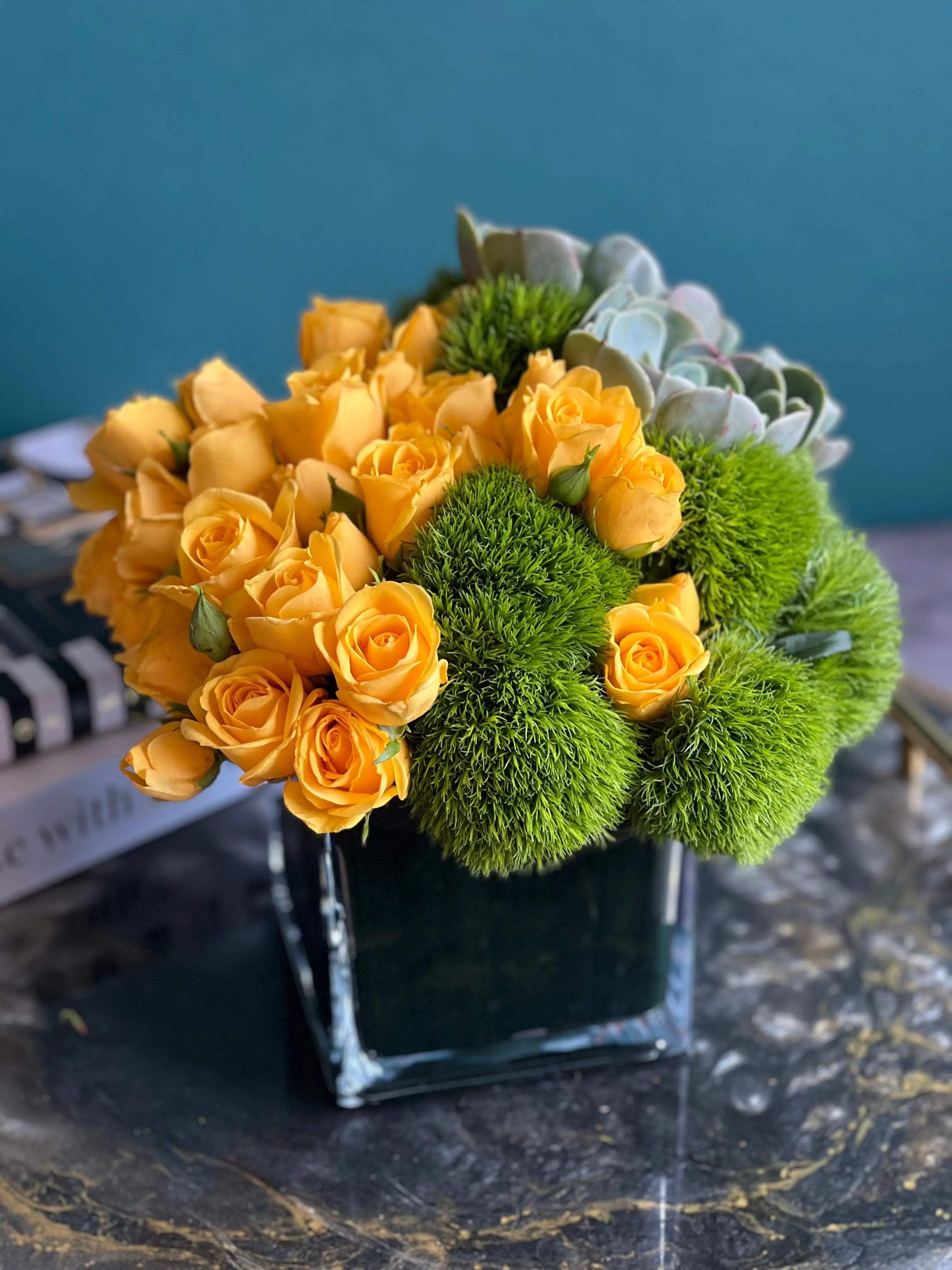 Modern yellow mini rose and succulent flower arrangement