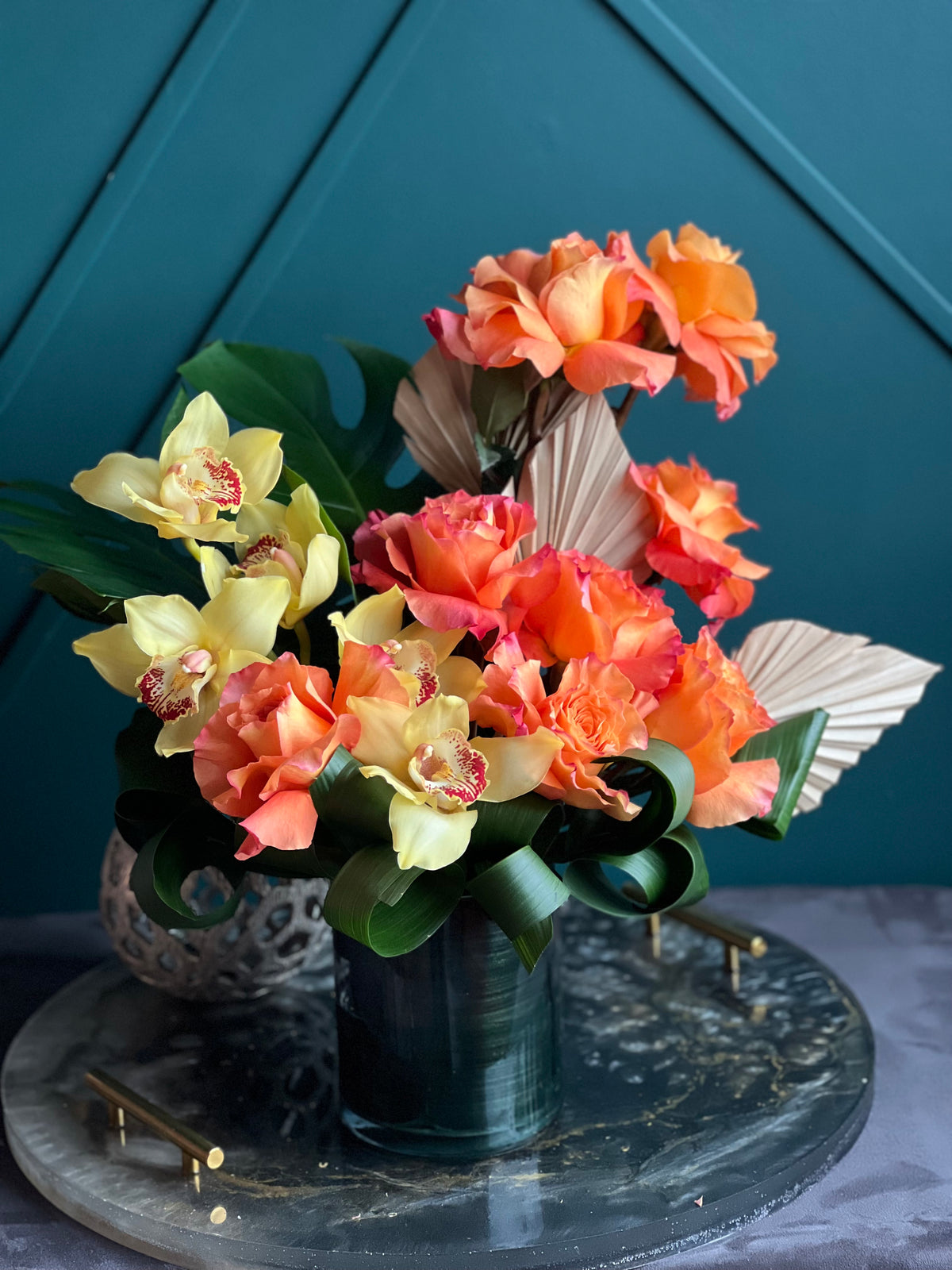 Orange roses and cymbidium orchid arrangement in Miami