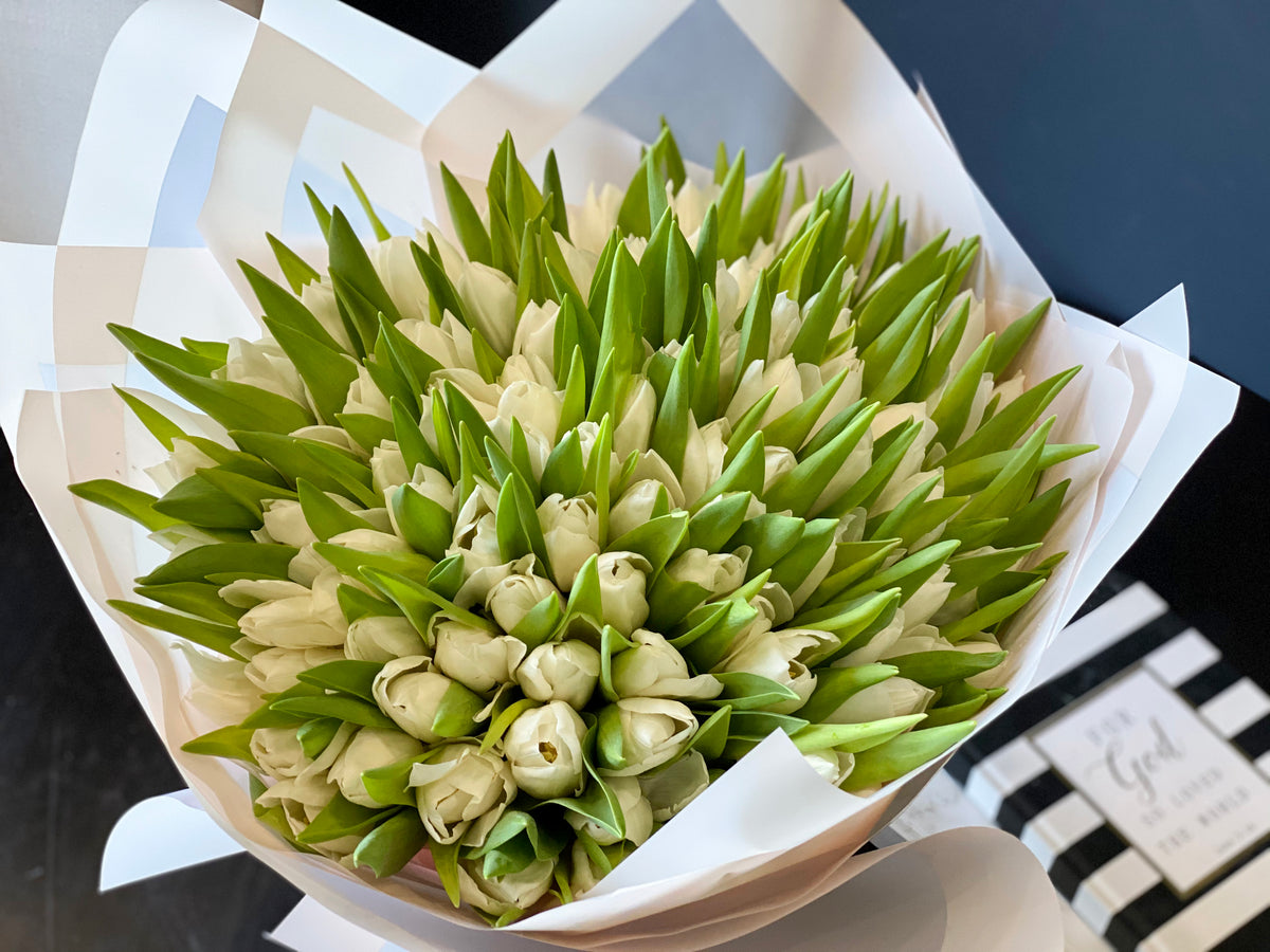 Oversized white tulip bouquet with decorative wrapping