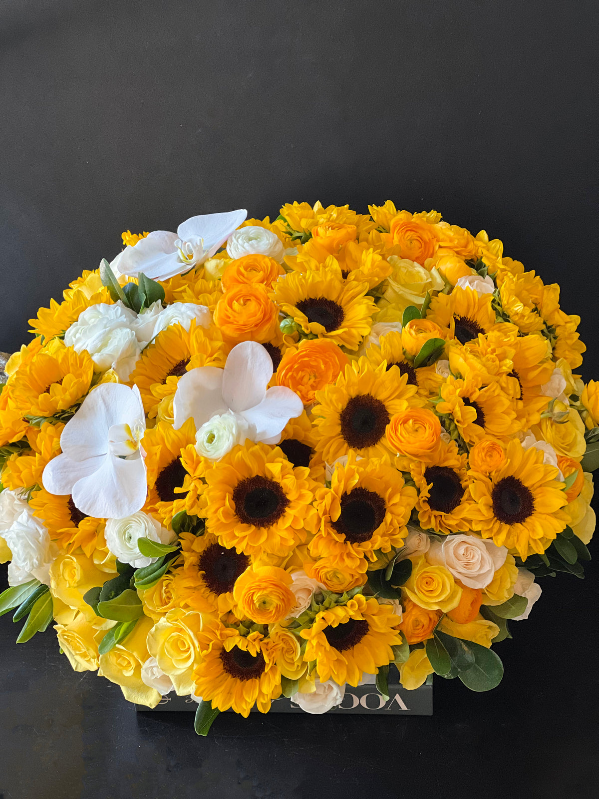 Oversized yellow flower arrangement with sunflowers and roses