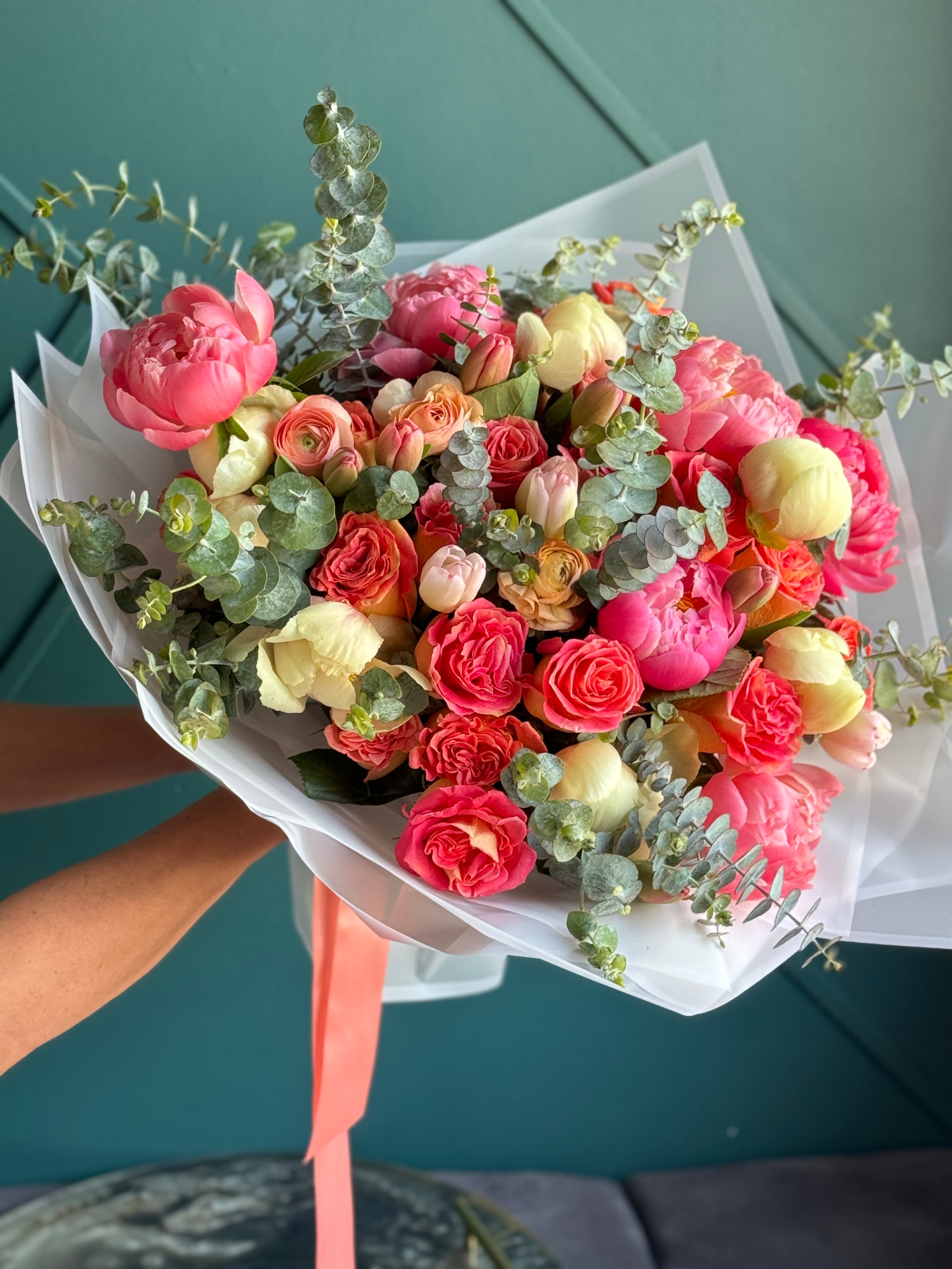 Peony and ranunculus bouquet with fresh eucalyptus greenery