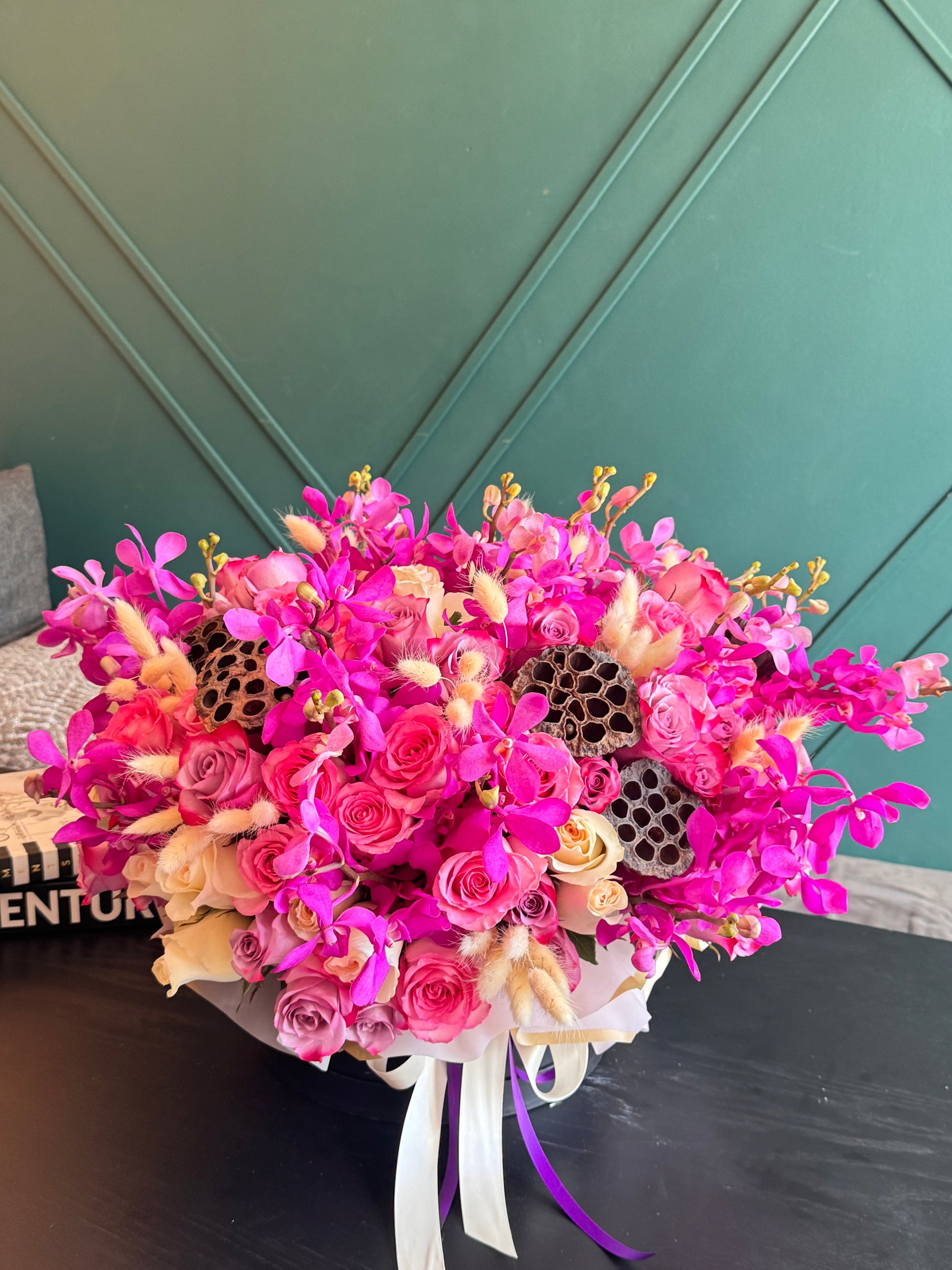 Pink Mokara orchids with roses and decorative accents