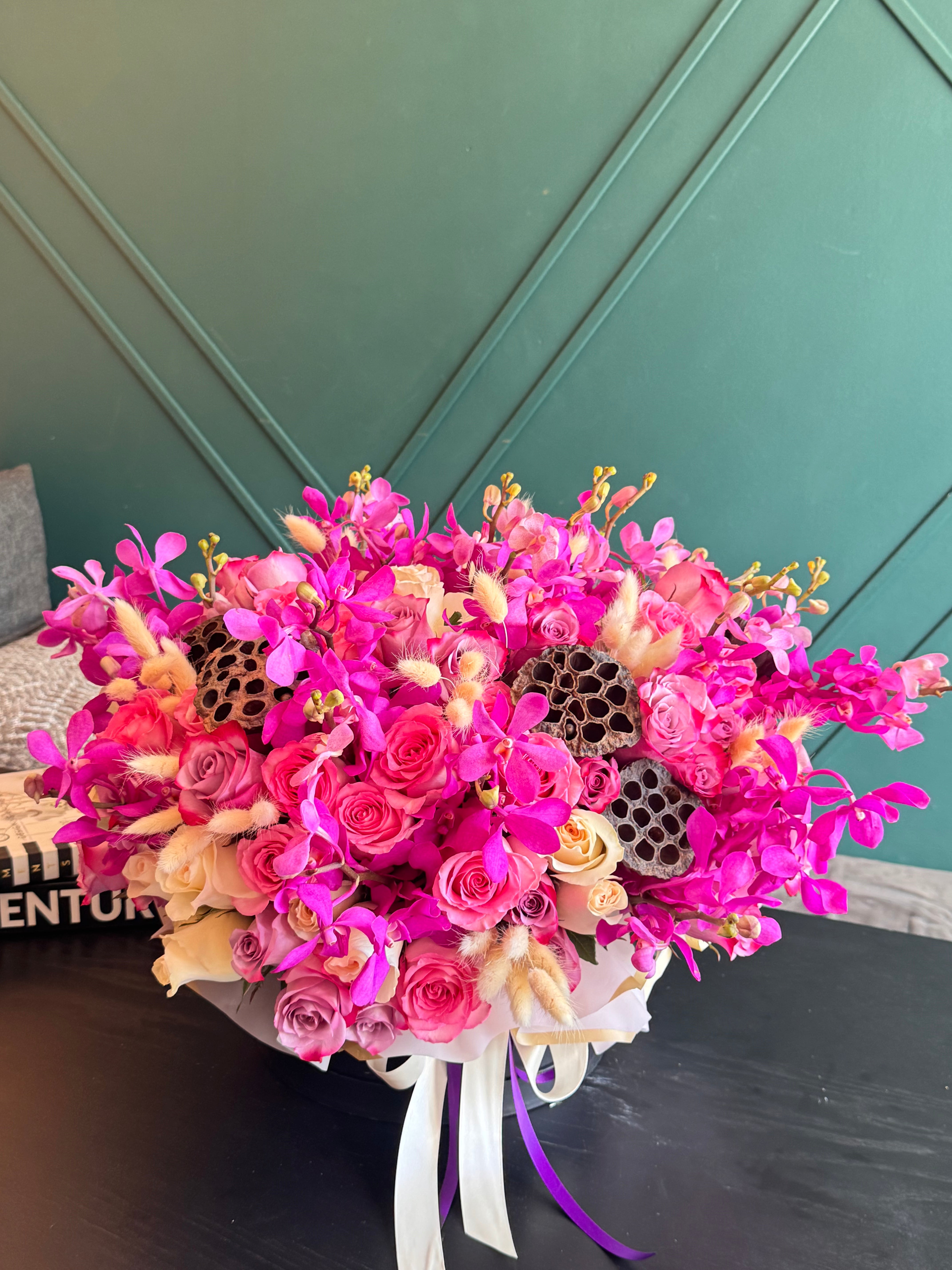 Pink Mokara orchids with roses and decorative accents