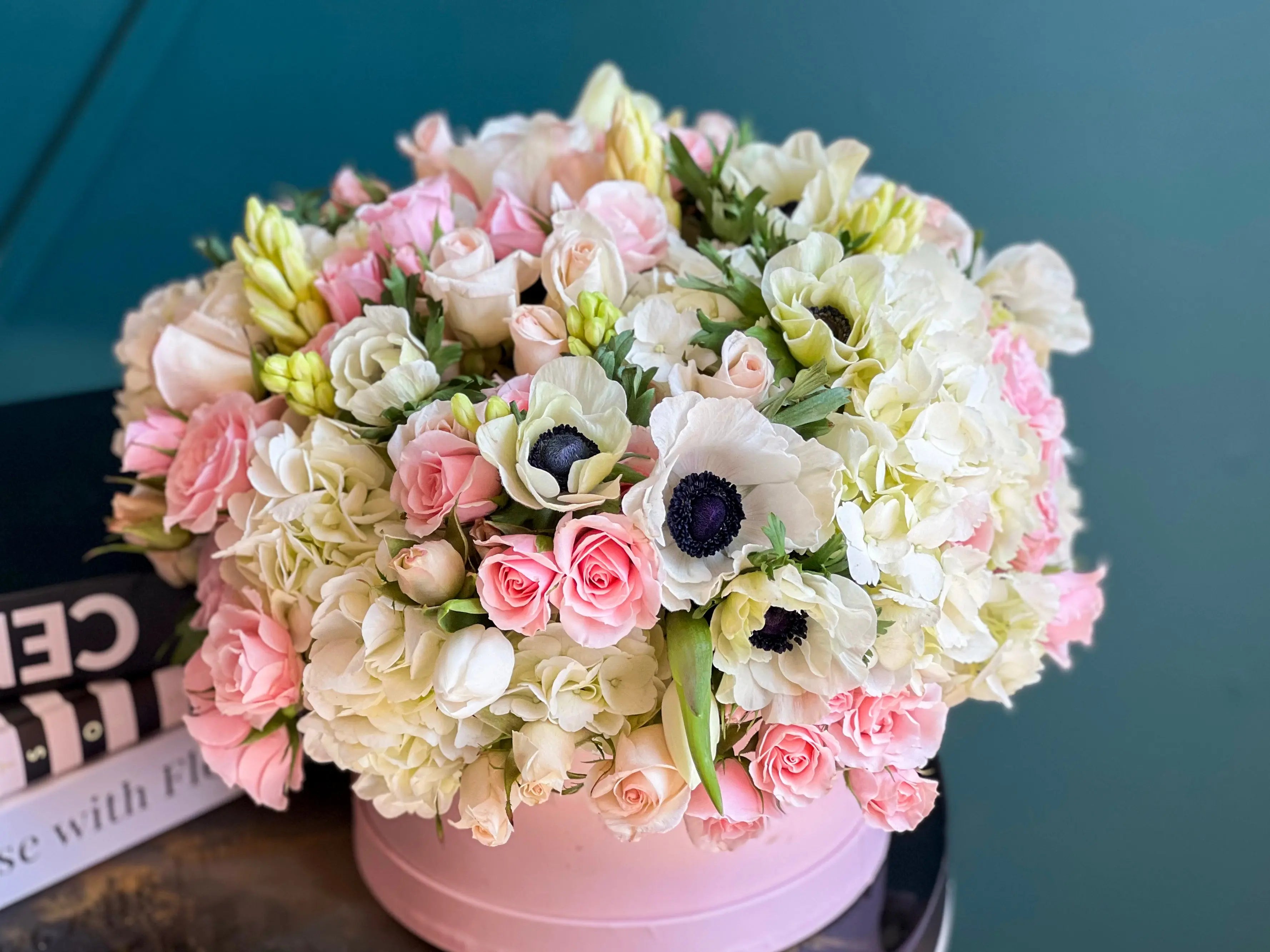 Pink and white hydrangeas and roses in a luxury flower box