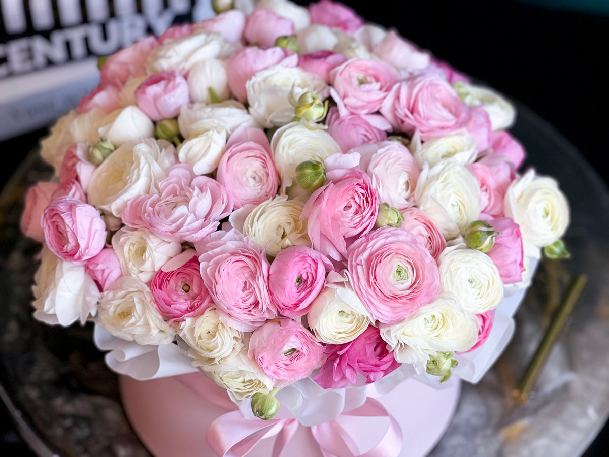 Pink and white ranunculus arrangement in luxury flower box