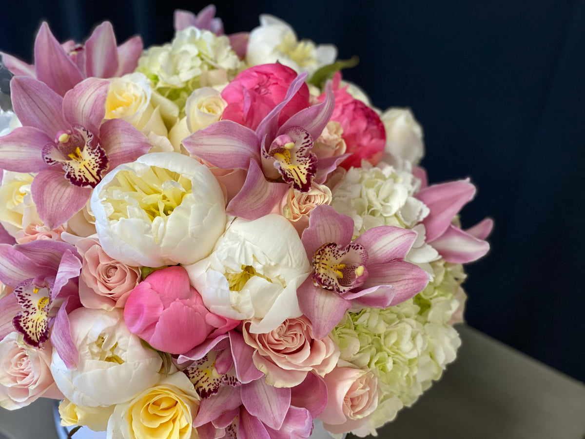 Pink flower arrangement with cymbidium orchids in Miami