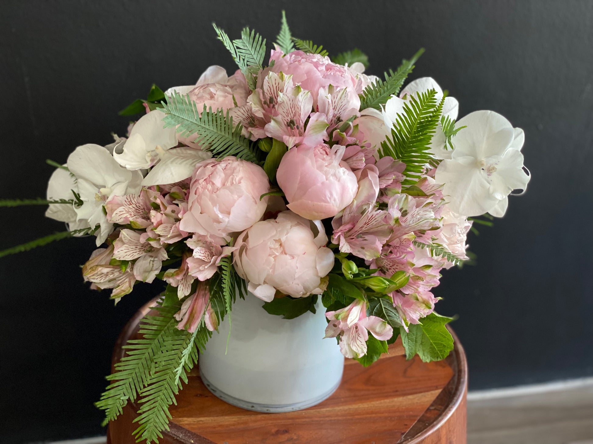 Pink peonies and Phalaenopsis orchid arrangement in vase