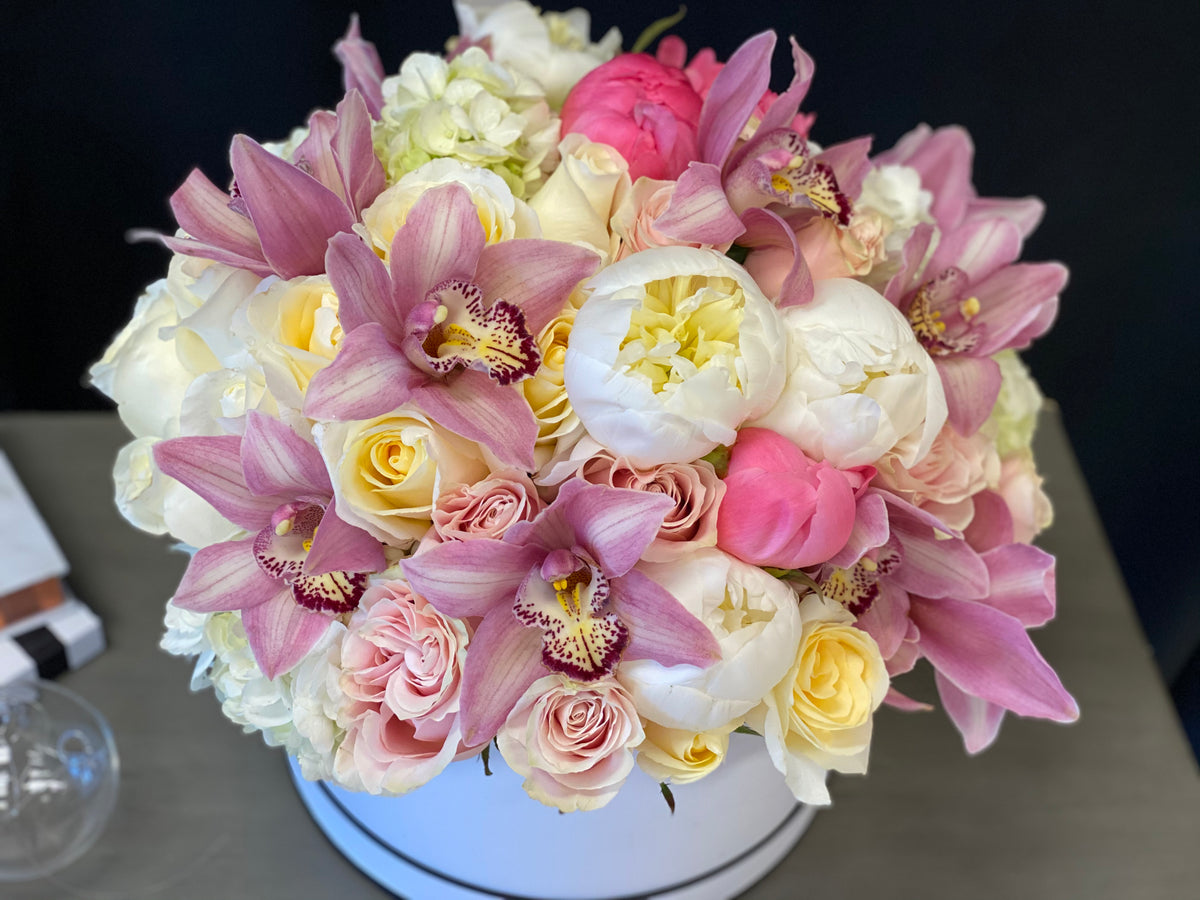 Pink peonies roses hydrangeas and cymbidium orchids