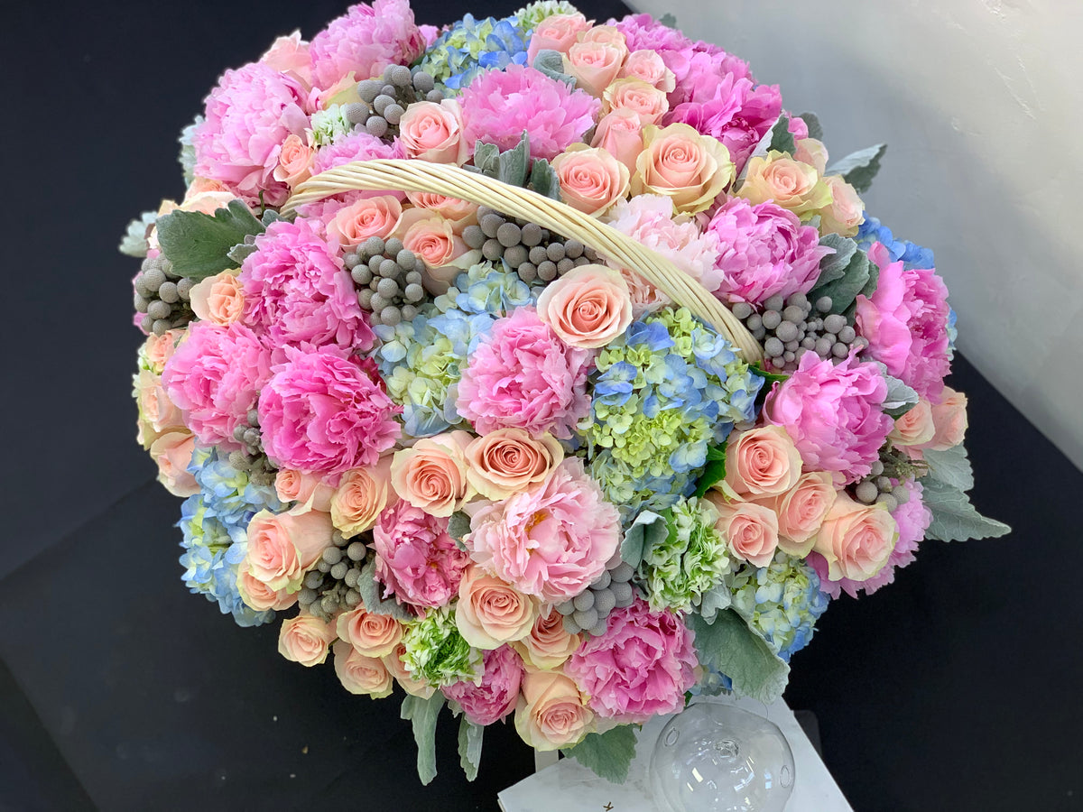 Pink peony and hydrangea basket arrangement with blush roses