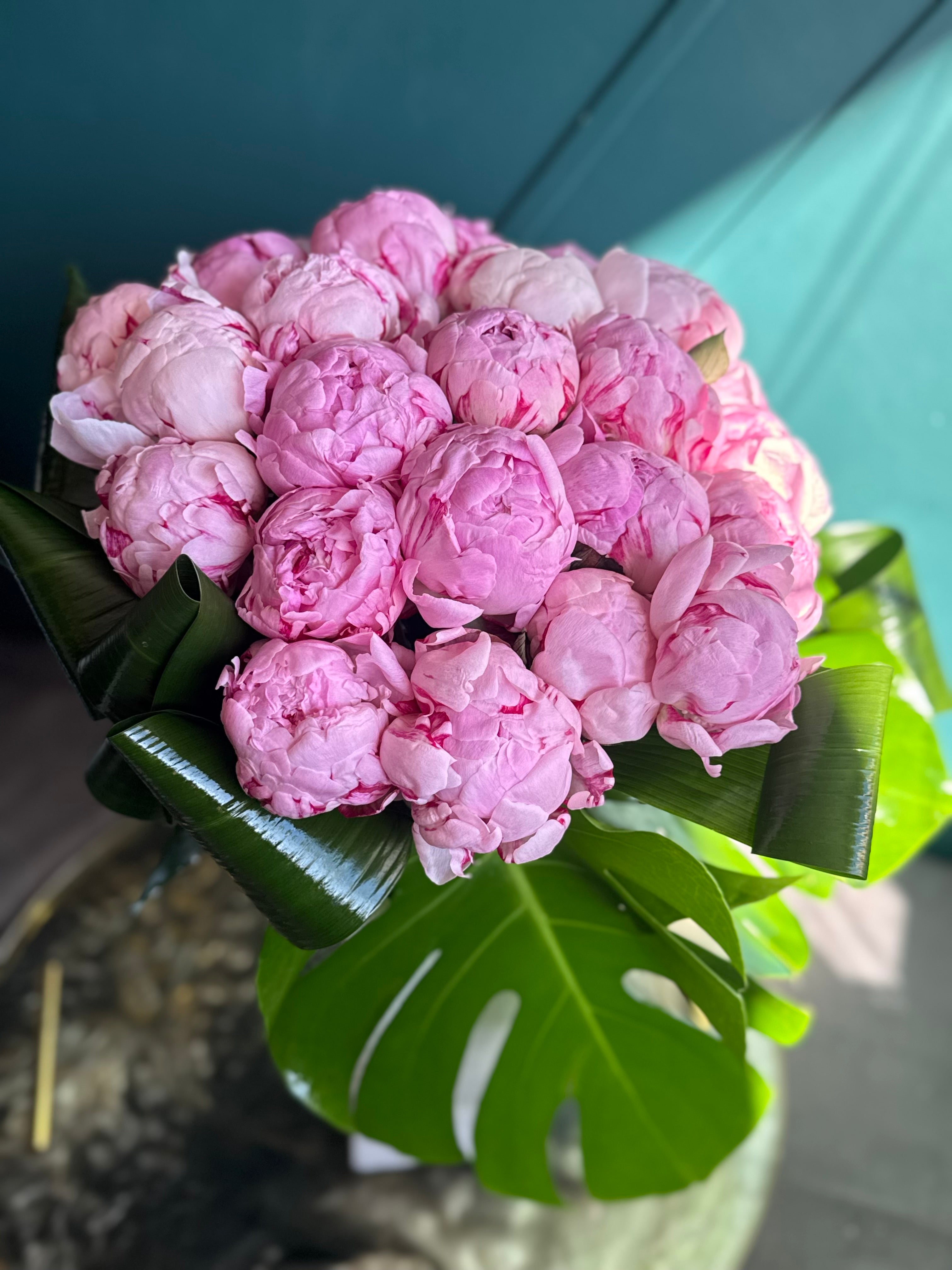 Pink peony flower delivery Miami with luxury tropical greenery